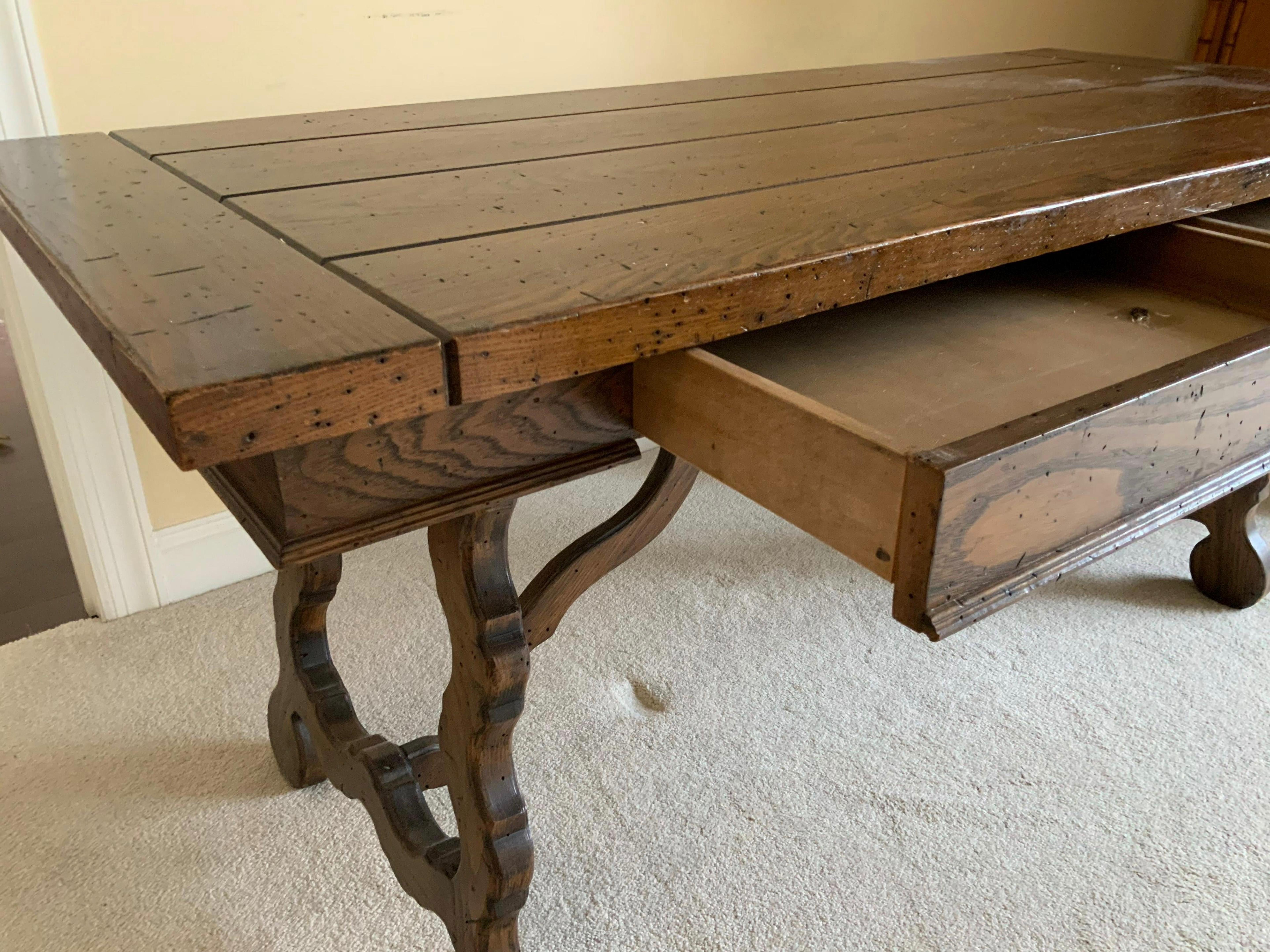 Spanish Renaissance style desk with two side by side drawers, thick top, and two harp design carved trestle pedestal leg supports, used as desk, dining table or kitchen table.
Search terms: Italian Renaissance, Spanish Baroque lyre style leg