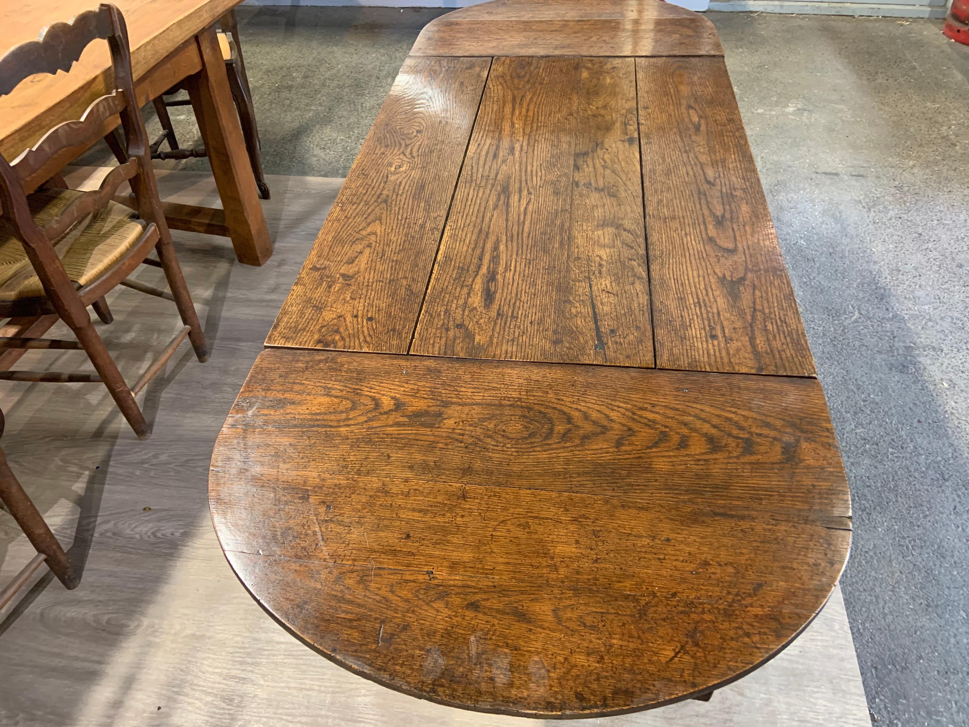 Antique trestle table with two half moon leaves. This table has a lot of character and sits on the most beautiful base. So versatile with the two leaves. Table length without leaves 38.5