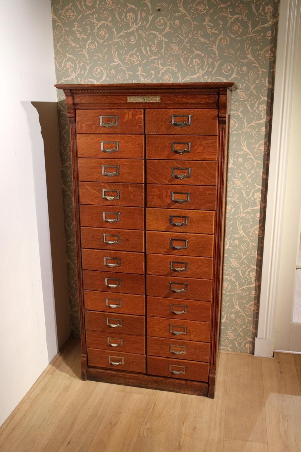 Antique oak filing cabinet with 24 filing drawers  from the American firm Wabash Cabinet Company. Entirely in very good and usable condition. The drawers still have the original labels and storage systems. Drawers are made in such a way that they