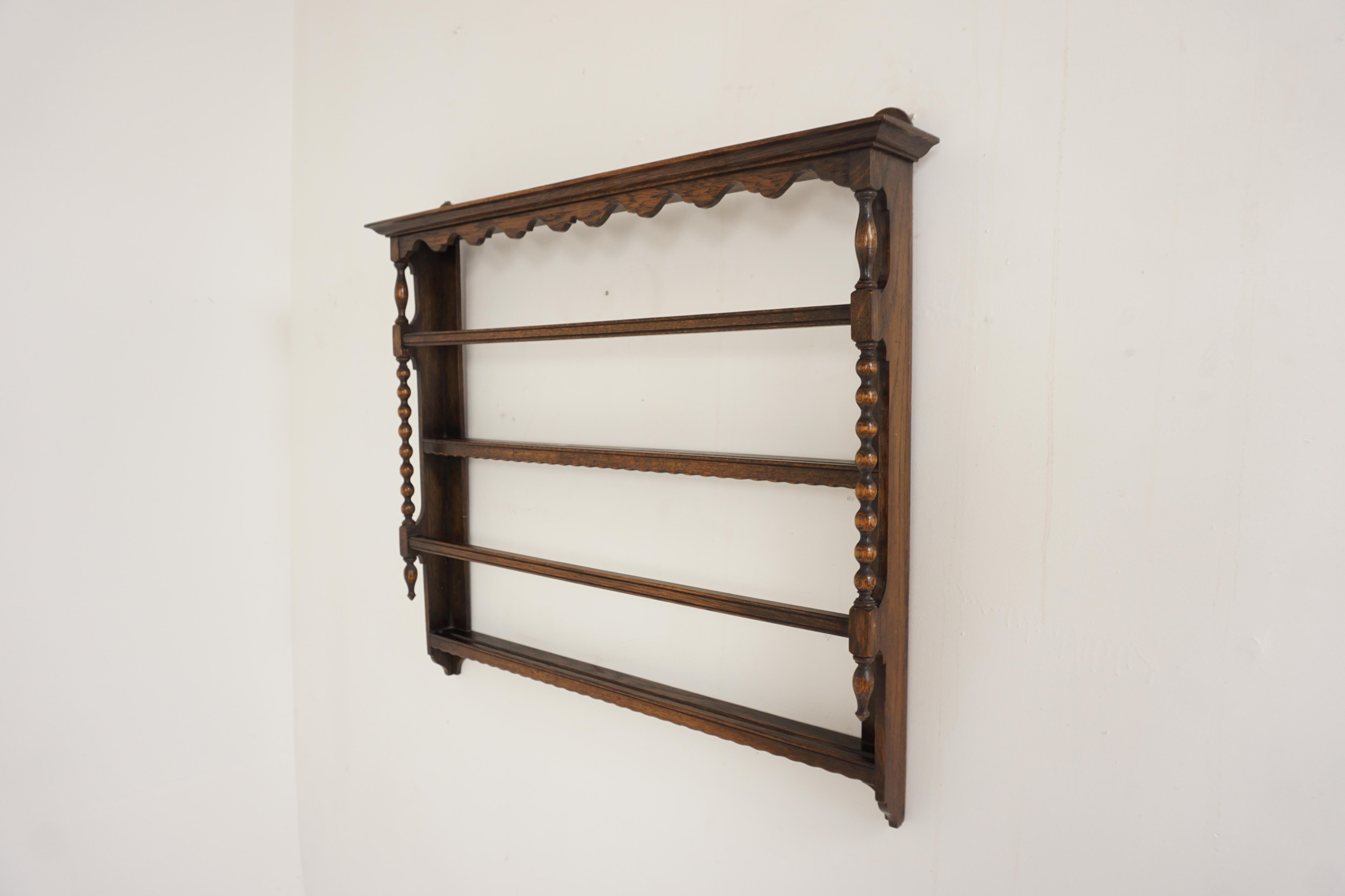 Antique oak wall hanging plate rack delft rack, Scotland 1910, B2649

Scotland 1910
Solid oak
Original finish 
Moulded cornice on top
Shaped valance underneath
Sturdy hangers to the back
Pleasing decorative bobbin uprights
Complete with 3