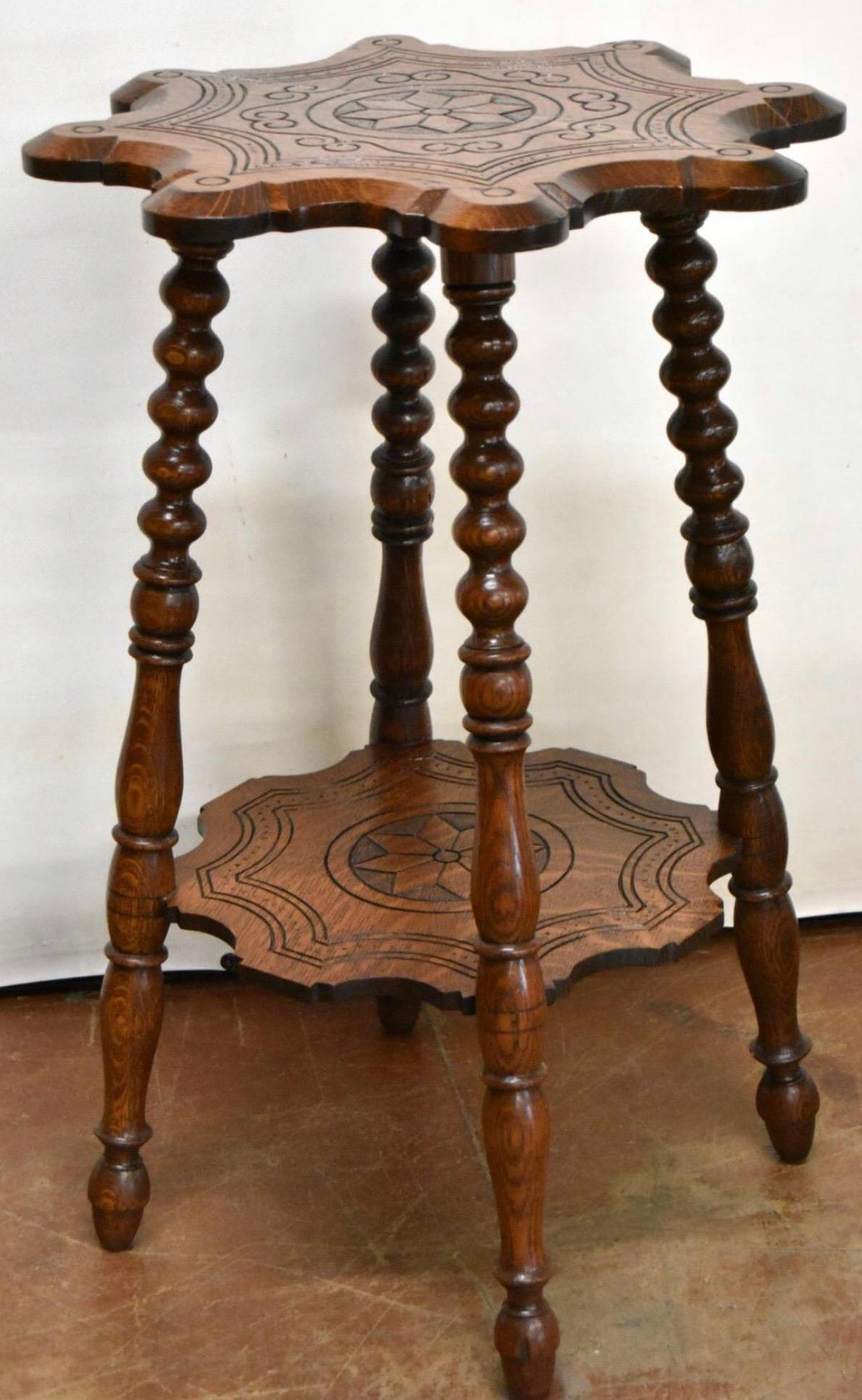 Antique oak parlor table features hand carved top resembling a western star or badge and second shelf
Measures 29 in Tall, 19 in Deep.
