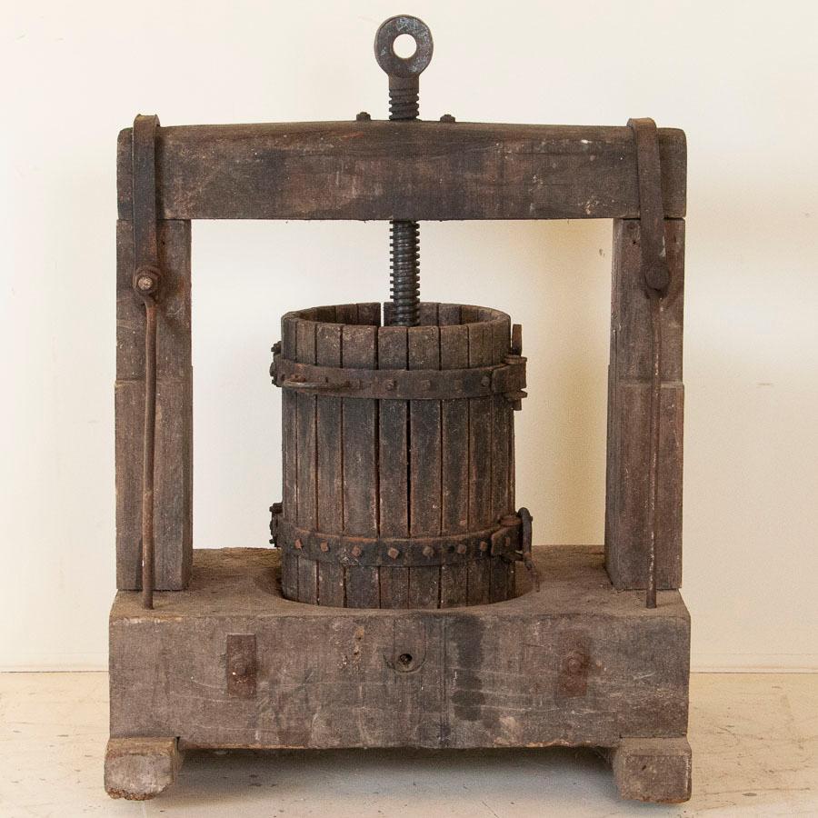 This wine press is a rare find, handcrafted from solid oak, circa 1900. The heavy gauge of the hand-thread iron shows dramatically against the oak, creating a strong visual appeal. This will be an exceptional addition to any wine cellar, winery or