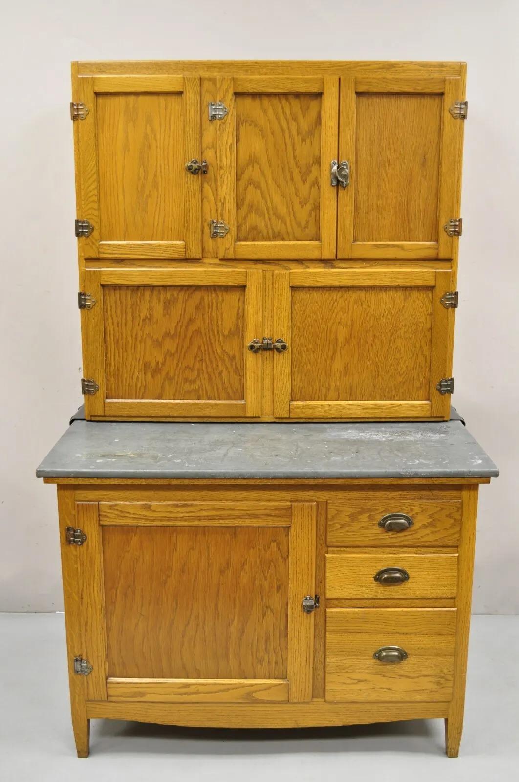Antique Oak Wood Hoosier Style Cabinet with Pull Out Zinc Metal Top  Item featured is a 2 part construction, beautiful oak wood, pull out surface with zinc metal wrapped top, very nice antique Hoosier. Circa Early 1900s..
Measurements: 
Overall: 68