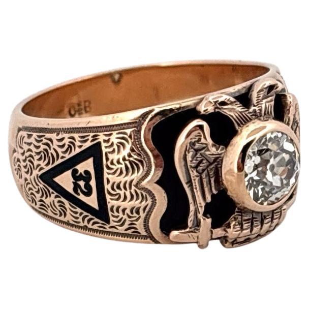 Crafted by the renowned Ostby & Barton, this exceptional vintage ring is a distinguished example of early 20th-century Masonic jewelry. Made of solid 10k yellow gold, it showcases a bold and intricate design enriched with hand-applied black, red,