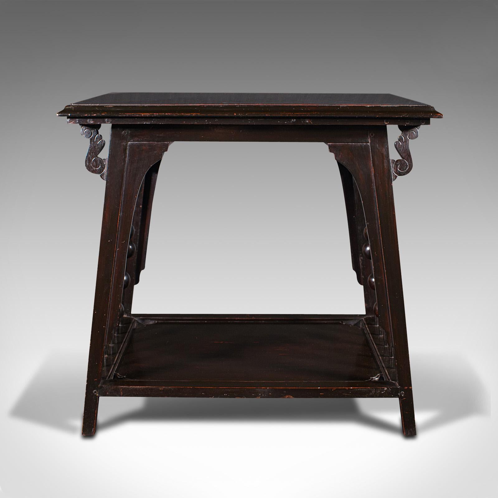 This is an antique occasional table. An English, ebonised side or lamp table in the manner of E.W. Godwin and the Aesthetic movement, dating to the Victorian period, circa 1880.

Distinctive two tier table with strong Aesthetic period