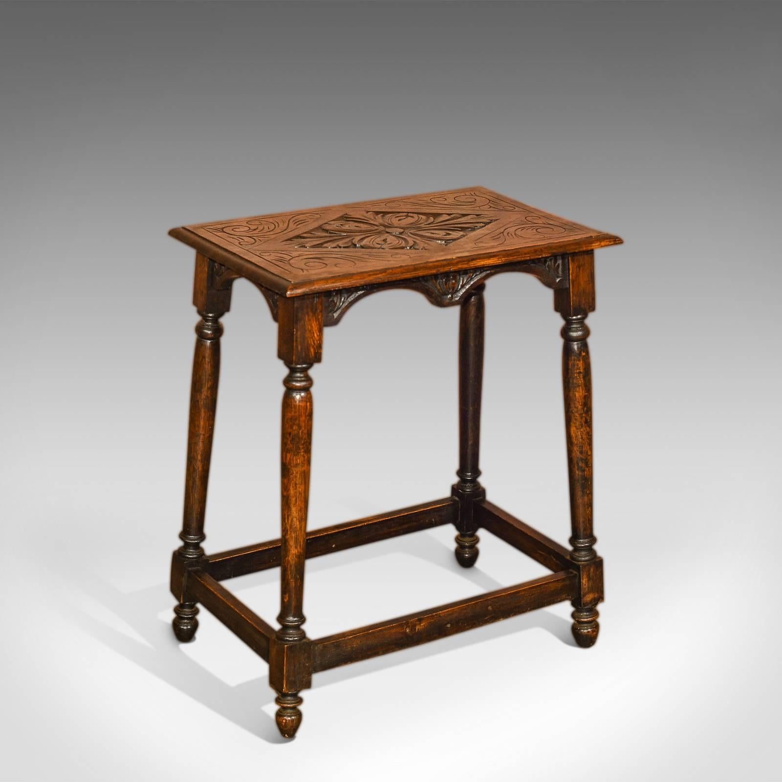 This is an antique, Victorian, oak occasional table dating to circa 1890.

Raised on turned oak legs and feet with square section where the boxed stretcher unites them, this diminutive side table carries a warm, country look. The dark, aged finish