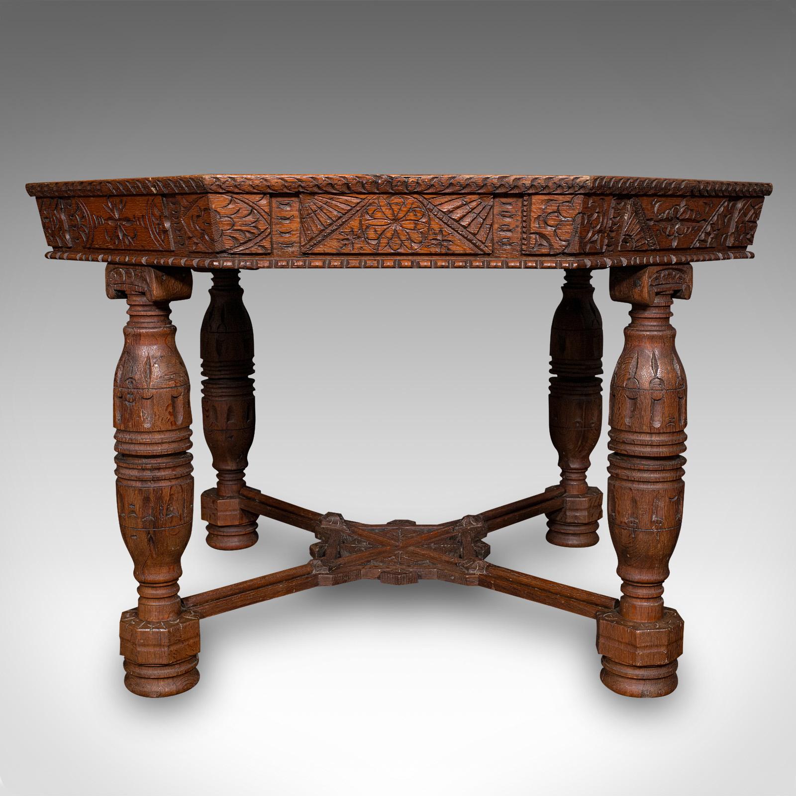 
This is a large antique octagonal centre table. A Scottish, carved oak Gothic Revival display table, dating to the Victorian period, circa 1880.

Exceptional Scottish craftsmanship with distinct carvings to each side
Displays a desirable aged