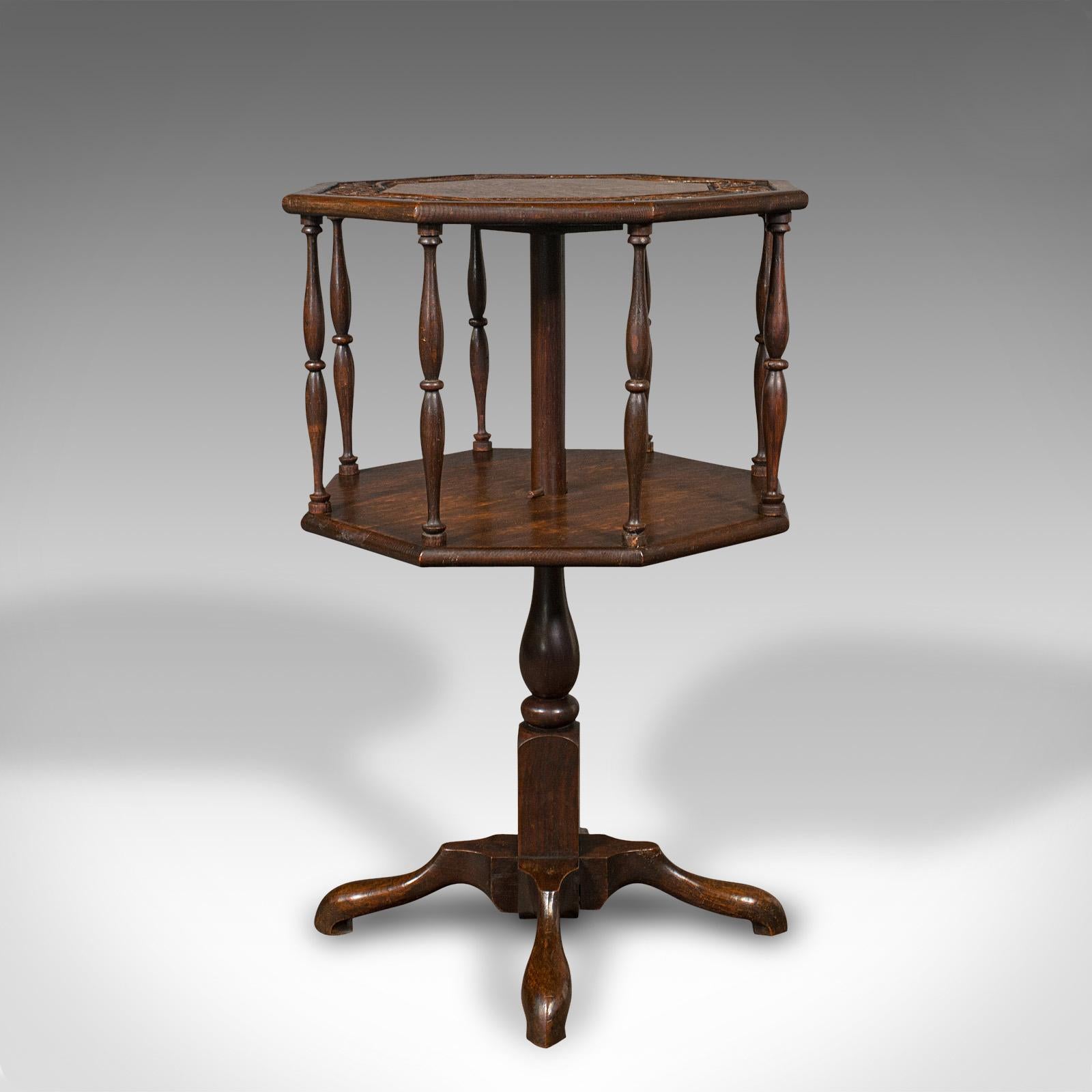 This is an antique octagonal occasional table. An English, oak rotating two-tier book shelf in the Arts & Crafts taste, dating to the late Victorian period, circa 1890.

Versatile and attractive addition to the lounge or reading nook
Displays a