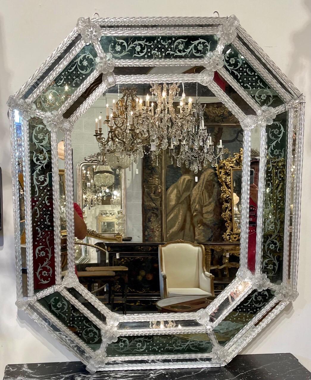 Lovely antique octagonal Venetian mirror. The piece has a beautiful etched mirror and Venetian glass on the borders including flowers. Very nice! Note: There are a few flowers that are missing that will be restored prior to shipping.