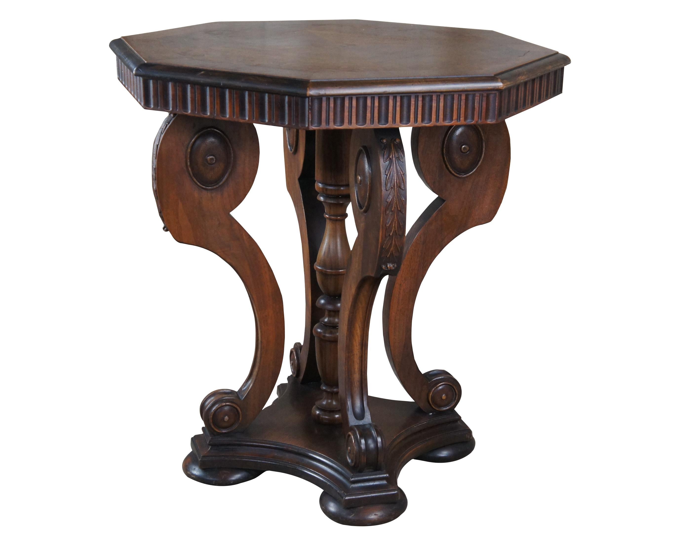 Antique Victorian parlor center table or stand.  Made of walnut featuring octagonal form with fluted accents, serpentine supports with carved acanthus leaves, turned trophy urn accent and bun feet.

Dimensions:
28.5