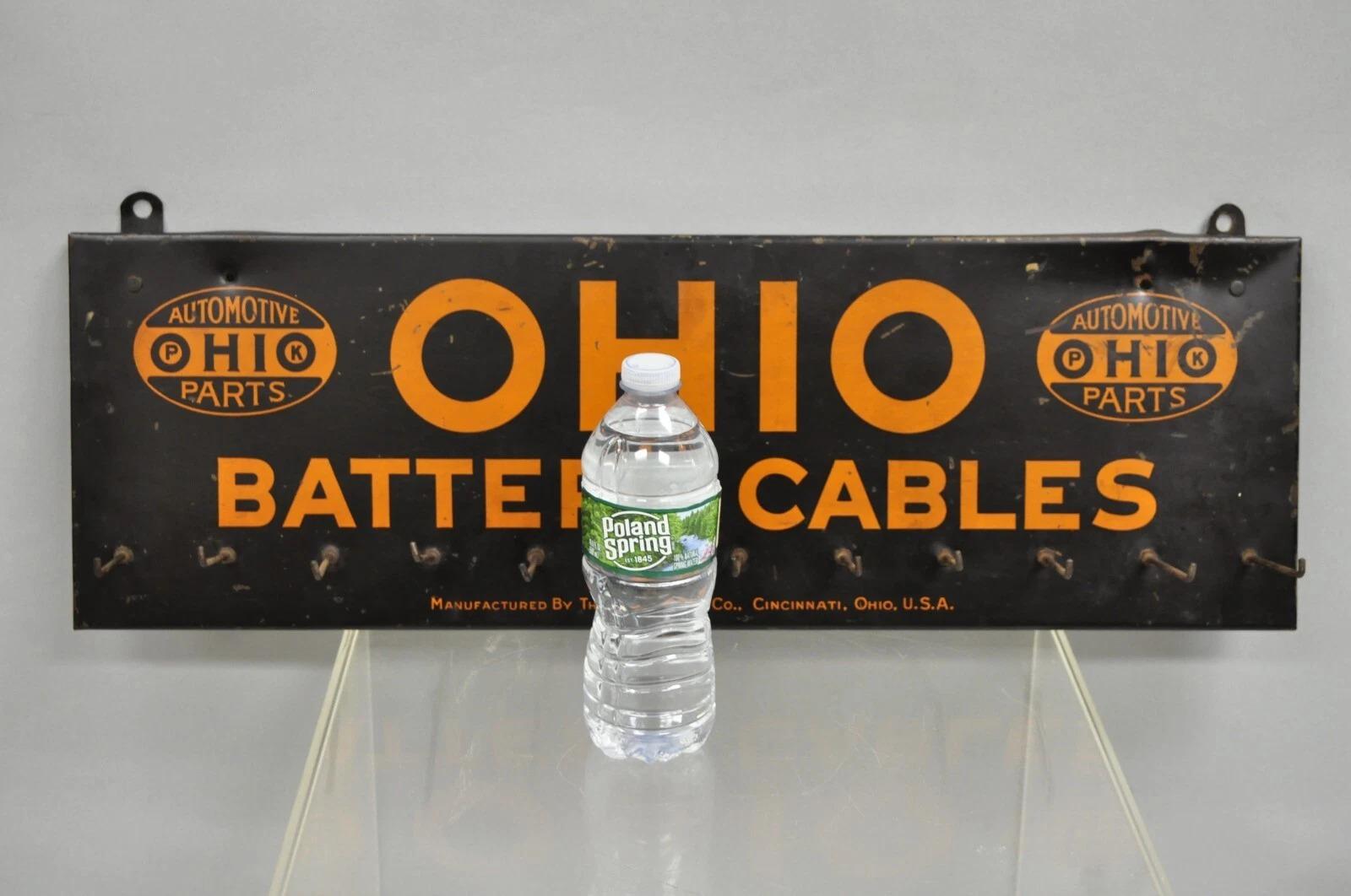 Antiguo Ohio Cables de Batería Estaño Metal Negro y Naranja Expositor de Piezas de Tienda c/ 12 Ganchos. Principios del siglo XX. Medidas: 8,5