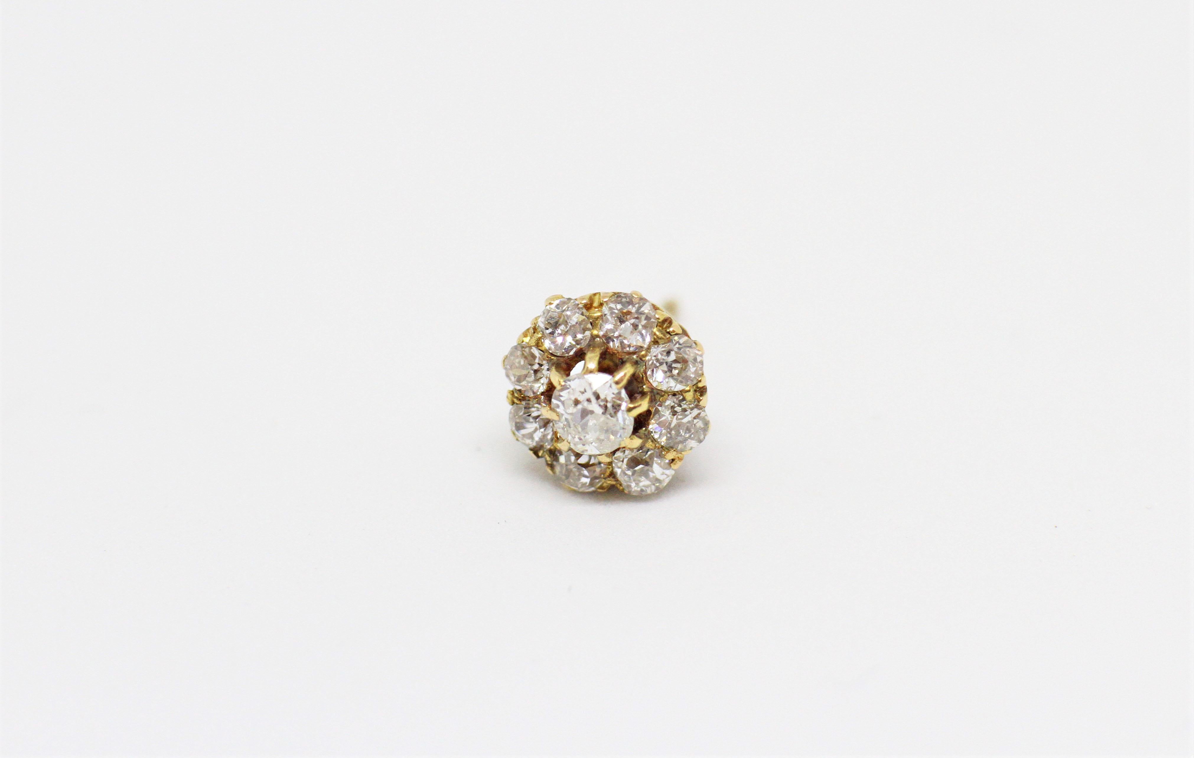 Old cut diamond coronet cluster stud earrings set with nine round old cut diamonds in an open back claw setting, with a combined approximate total weight of 1.50 carats. Tested 18 carat yellow gold, Circa 1890.