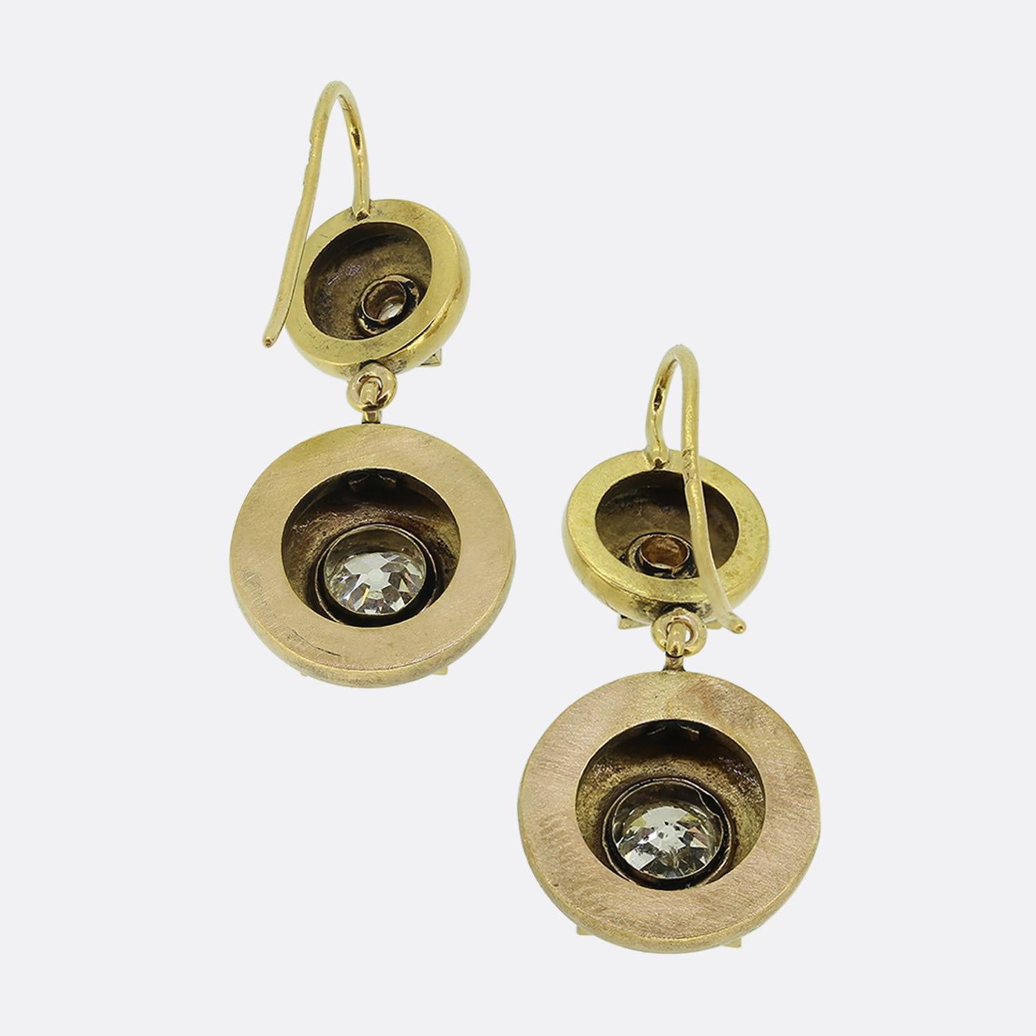 Here we have a splendid pair of diamond drop earrings dating back to the Victorian period. Crafted from 18ct yellow gold, each piece showcases a duo of circular domes; the smaller of which plays host to the larger below. Each motif has been set with