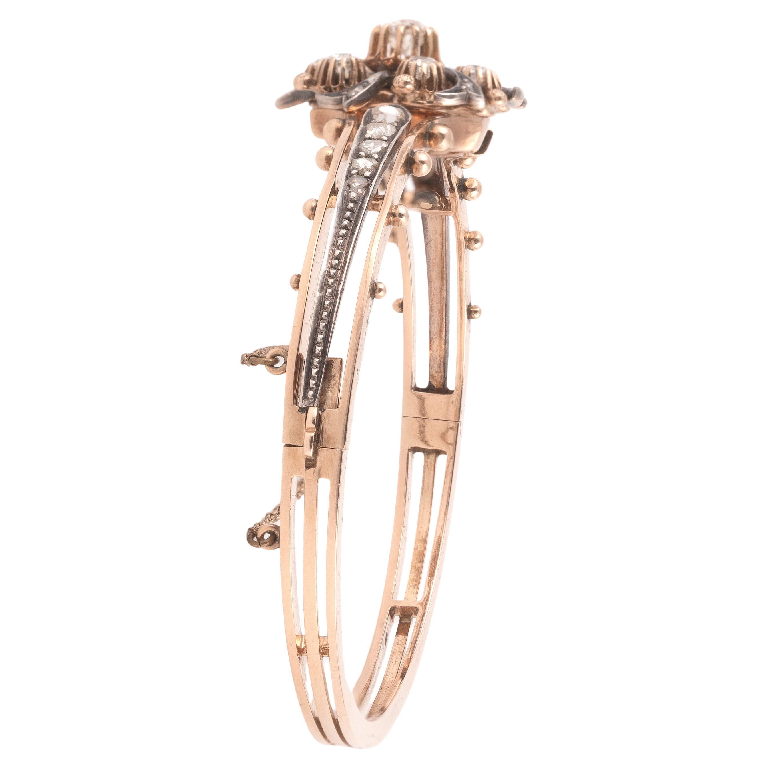 18 kt gold diamond-bangle , approx. 1860ca very fine workmanship, head part. silver, curved, sideways with small spheres, 7old cut diamonds and 16 diamond roses total approx. 1.50 ct 
Size approx. 5.8x 5 cm, folding hinge, case lock with safety
