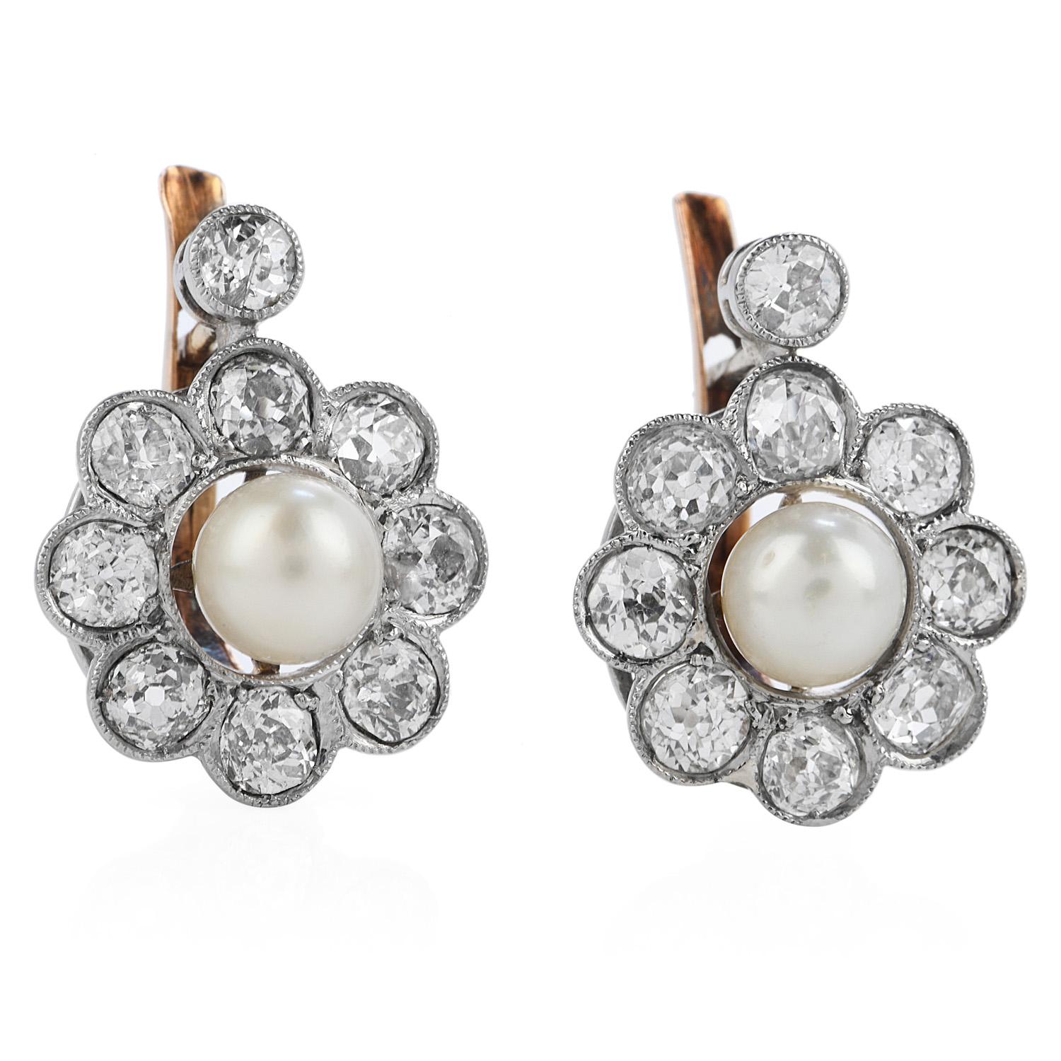 Antique 1940's two-tone floral-inspired dangle earrings,

Crafted in solid Platinum top & 18K yellow gold, topped by (18) Old-mine cut, bezel set Diamonds weighing approximately 1.90 carats (G-H) color and VS-SI clarity)

The center of each piece is