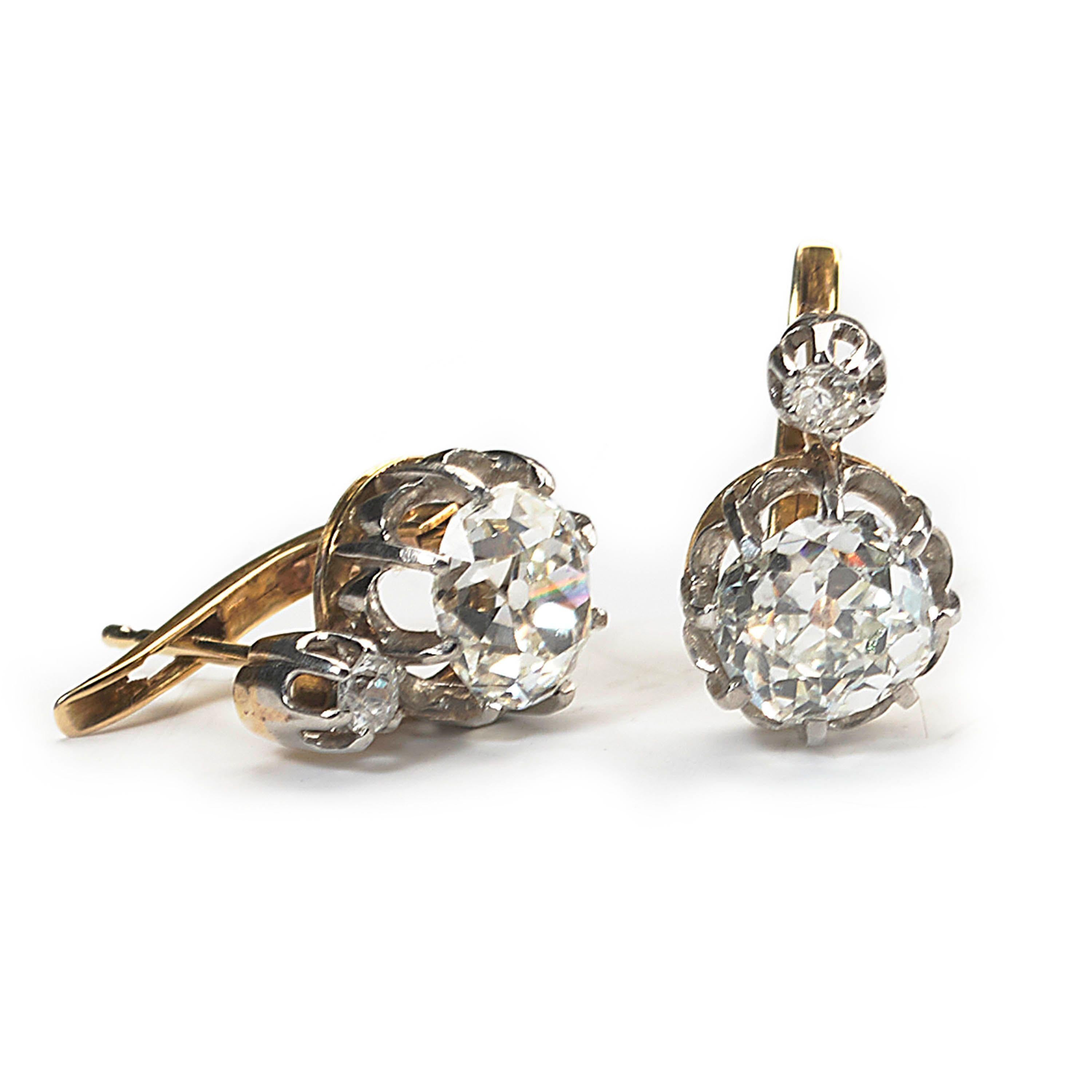 A pair of antique, cushion shaped, old-cut diamond earrings, with a pair of old European-cut diamonds, with a total weight of approximately 2.60ct, in our opinion the colour is J to K and our opinion of the clarity is VS, surmounted with single,