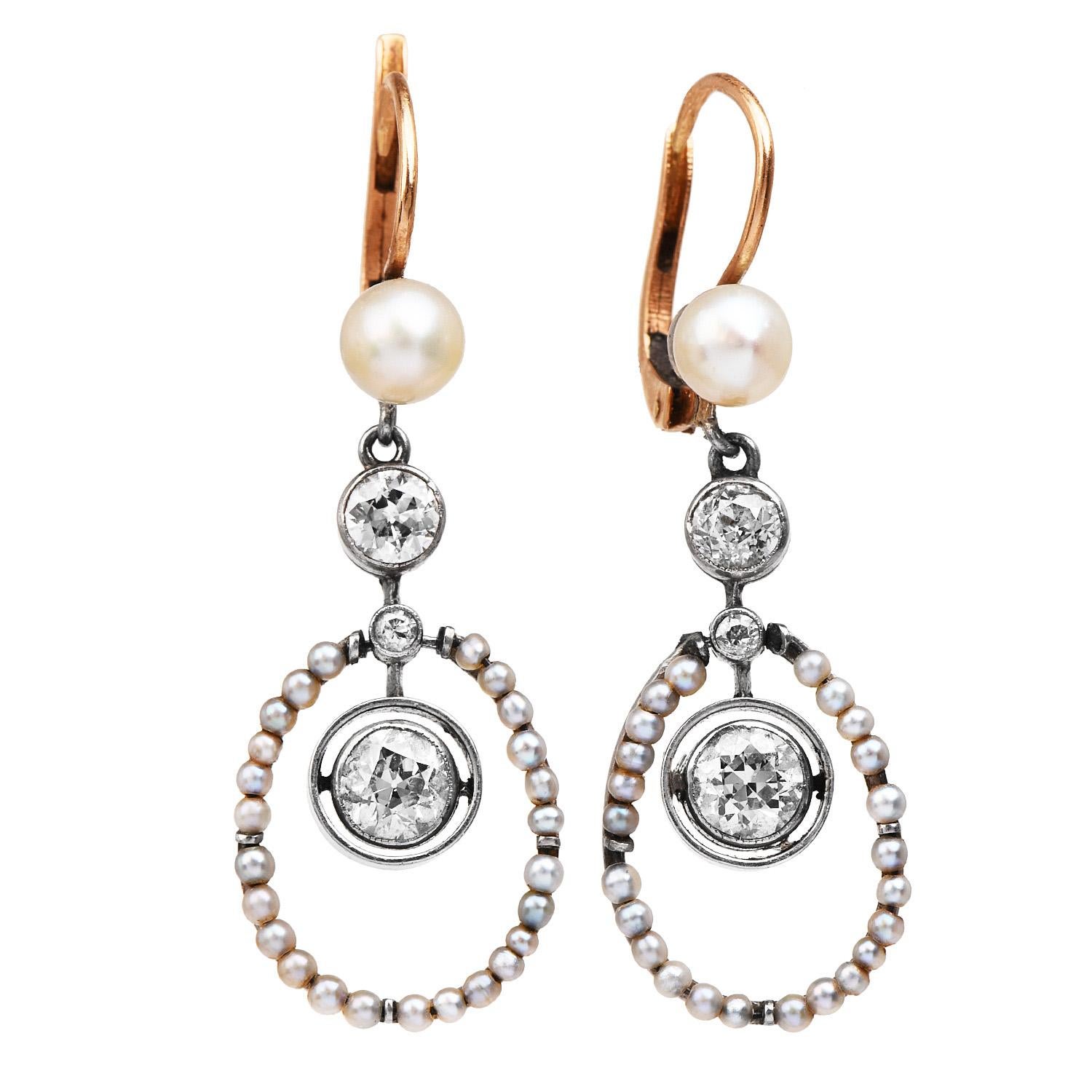 Exquisite Victorian Style antique diamond earrings are from circa the 1930s.

They display a halo design made of genuine seed pearls, measuring approximately 1.25 mm each and topped by two cream tone high luster pearls of 5 mm each.

Complementing