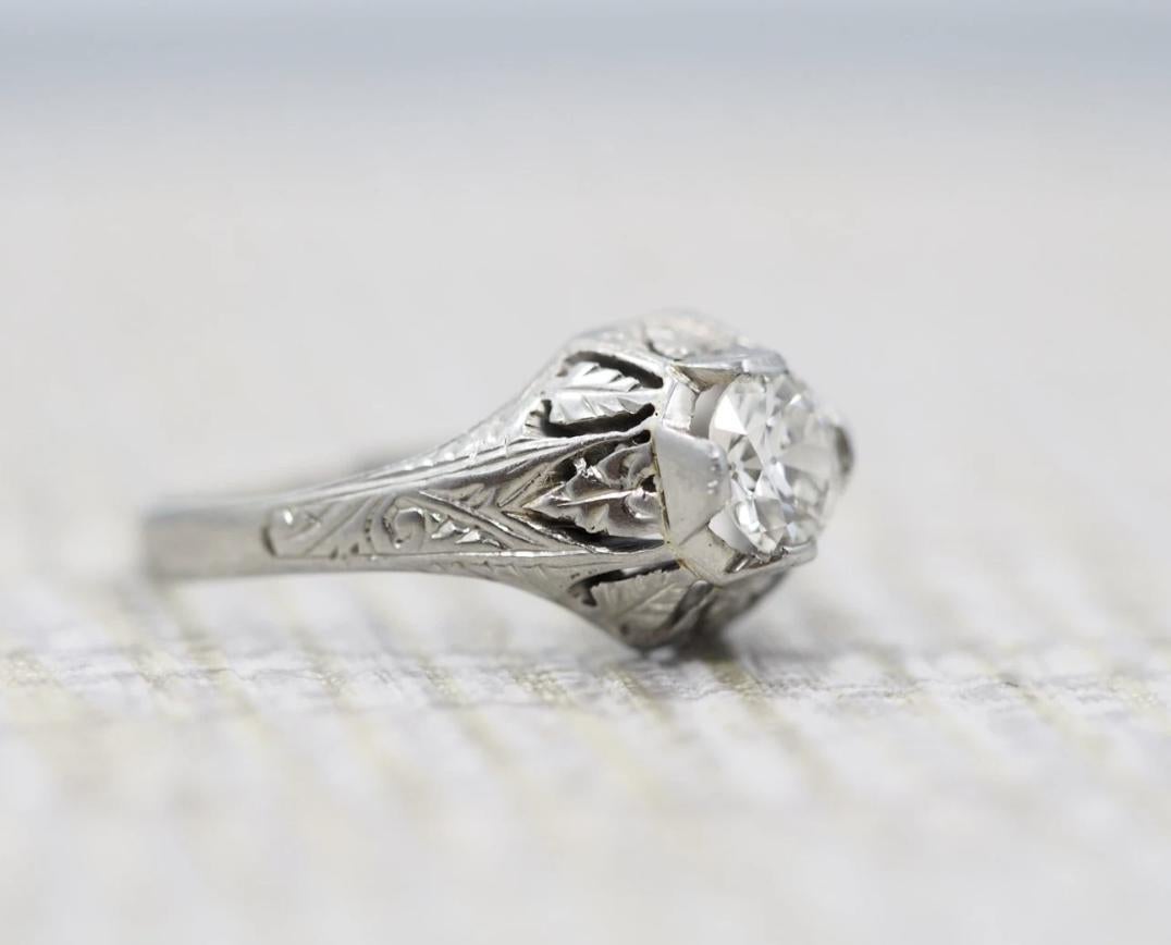 Item Description:
Here we have an absolutely stunning antique enagagement ring. The prongs are something to be in awe of, as we do not often see the elevated prongs often in an antique setting. There is beautiful floral hand carved design around the