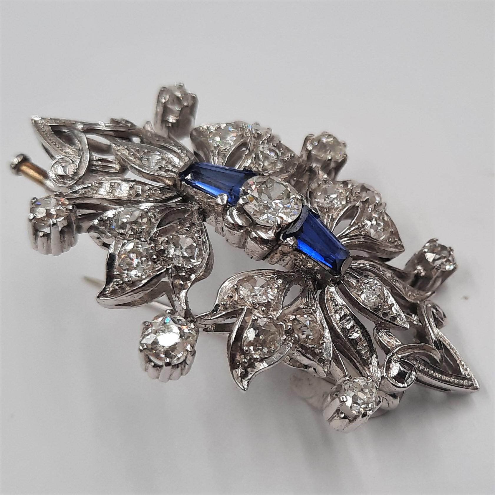 Extraordinary antique 18 carats white gold  and platinum (16.20 grams) brooch with an old European cut diamond at the centre (0.60 carats), blue stones and rose cut diamonds (2.90 carats). No hallmarks or stamps, but tested.