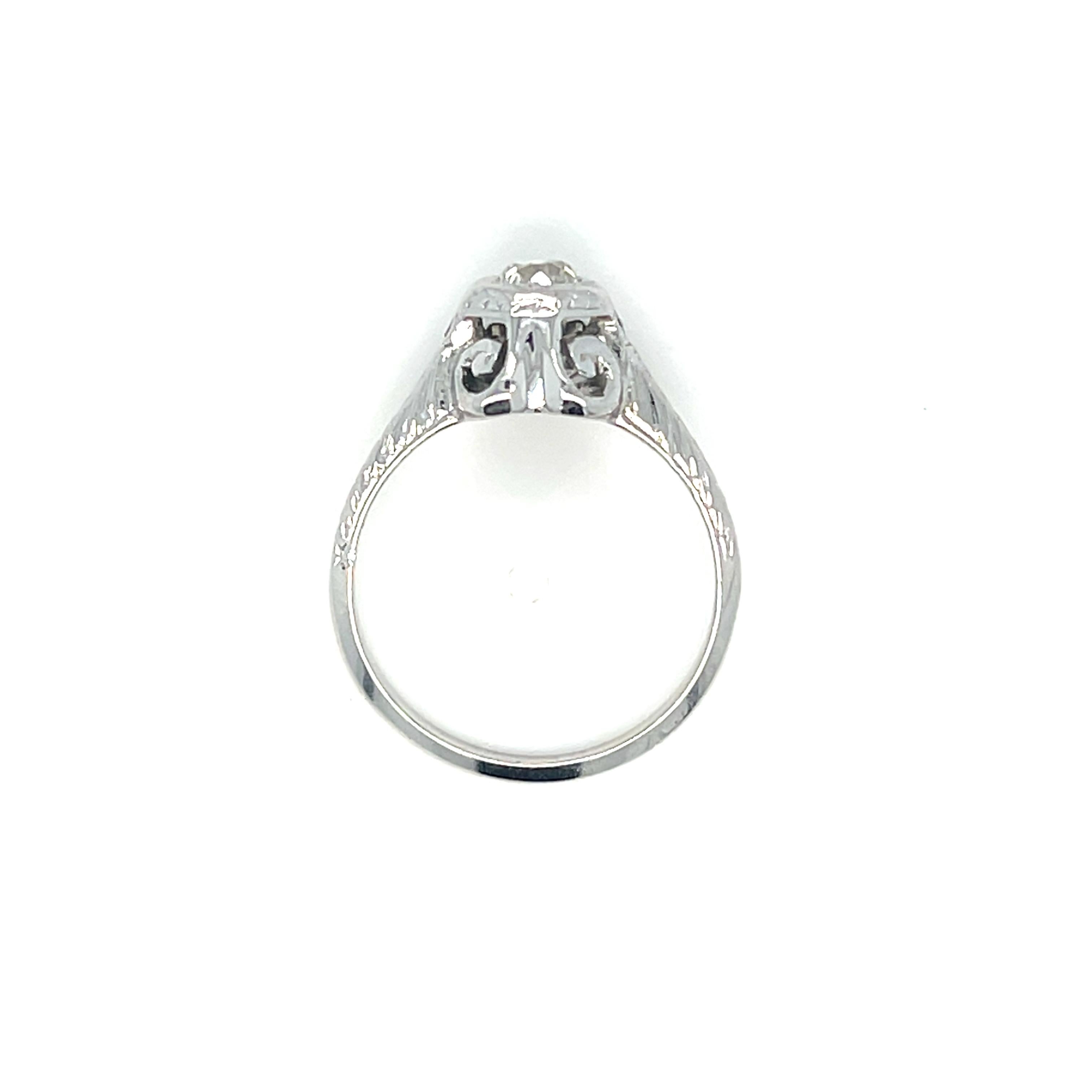 This stunning vintage ring showcases a dazzling Old European cut diamond at its center, offering timeless elegance and exceptional sparkle. The diamond, weighing approximately 0.25 carat, graded H in color and SI1 in clarity, is beautifully set in a