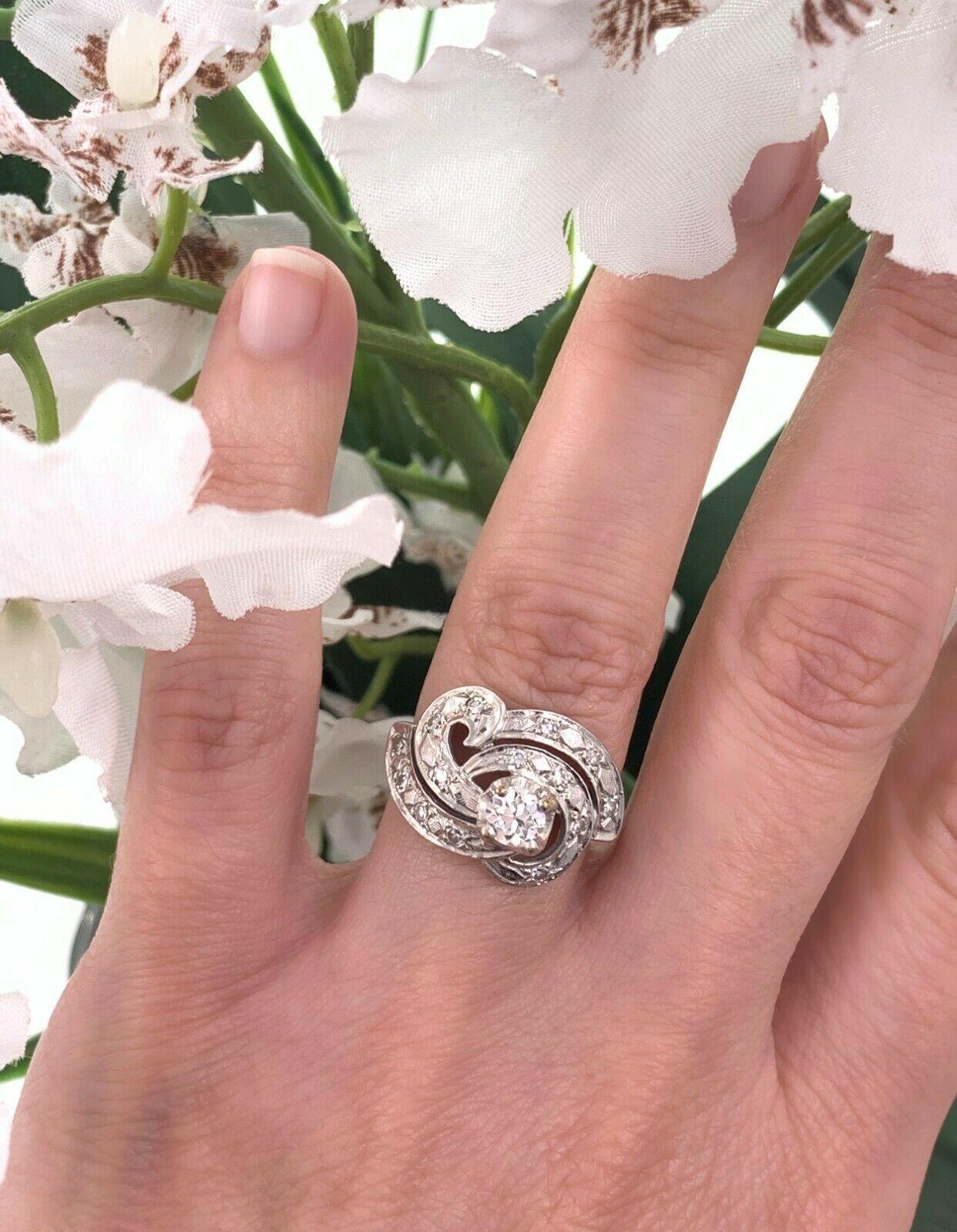 Antique Diamond Ring
Style:  Art Deco Swirl Ring
Metal: 14K White Gold
Size / Measurements:  6, sizable
TCW: 0.65 carats total approximate
Main Diamond: 0.33 Carat Old European Cut 
Accent Diamonds:  12 Single Cut Diamonds
Color & Clarity: H - I