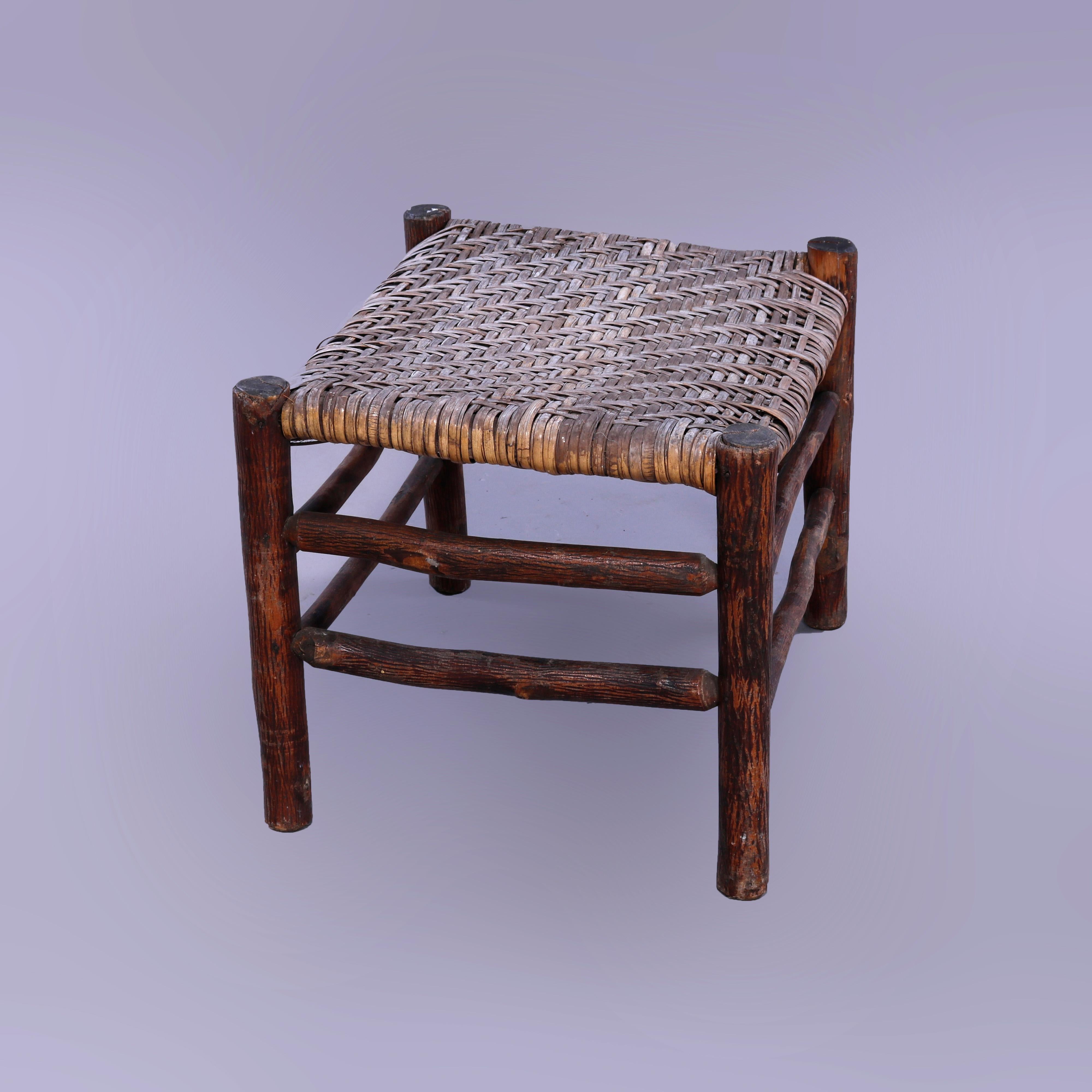An antique Adirondack bench in the manner of Old Hickory offers woven splint seat on stick form frame, unsigned, c1910

Measures - 16'' H x 22'' W x 17.5'' D.