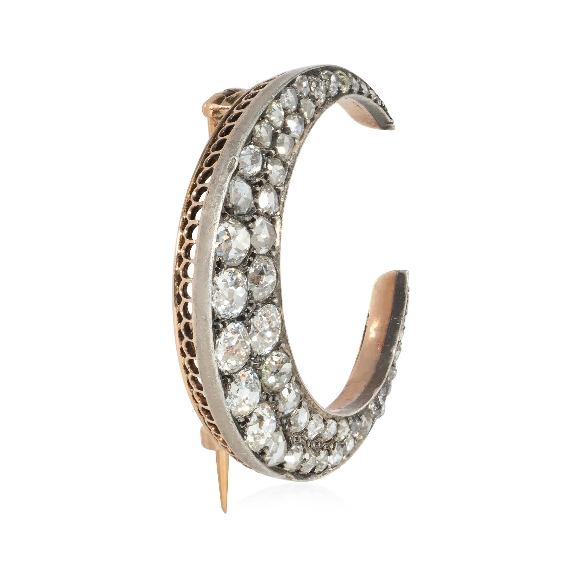 An antique Victorian period diamond crescent brooch comprised of old mine-cut and rose-cut diamonds, in 18k gold and silver.  Atw old mine-cut diamonds 1.84 cts.

* Includes letter of authenticity for insurance purposes
* Free shipping
* Please feel