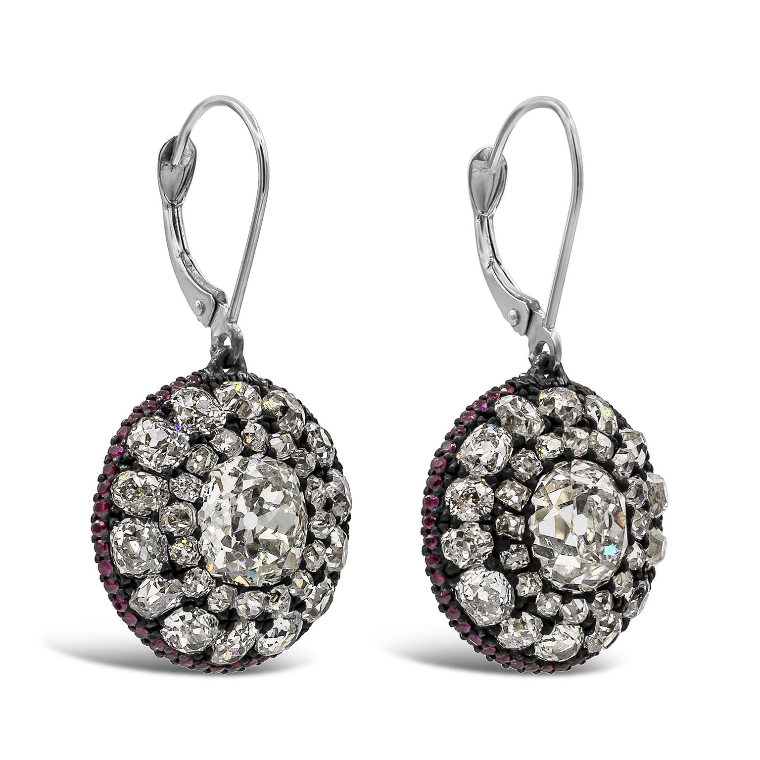 A contemporary antique pair of drop earrings showcasing two gorgeous old mine cut diamonds weighing 2.18 and 1.75 carats, surrounded by a row of old mine cut diamonds. Accent diamonds weighing 5.20 carats total. Finished with ruby diamonds weighing