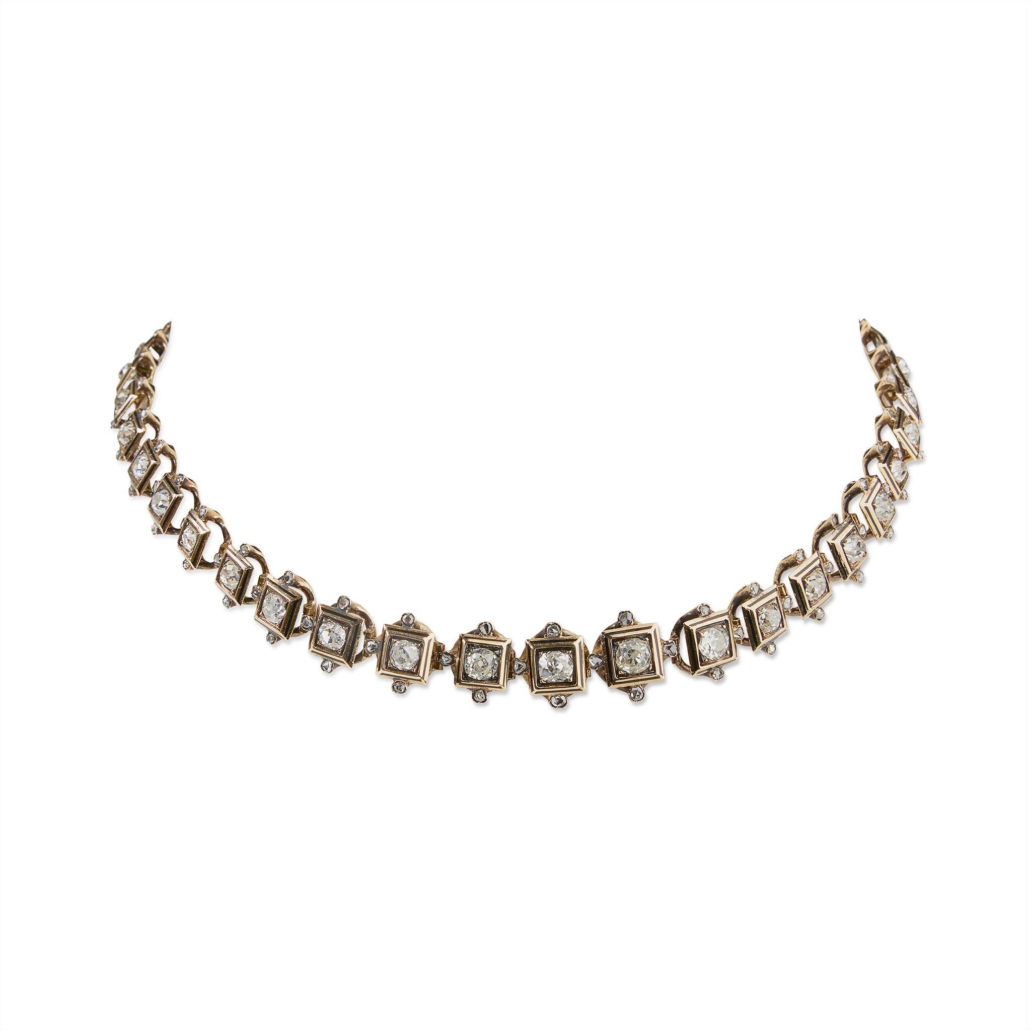 Composed of old mine and rose-cut diamonds, this rivière necklace is mounted in enameled 18K gold. Each old-mine cut diamond, graduating in size from approximately 0.50 carat to 0.15 carat, is box-set, with a champlevé black enamel surround, and