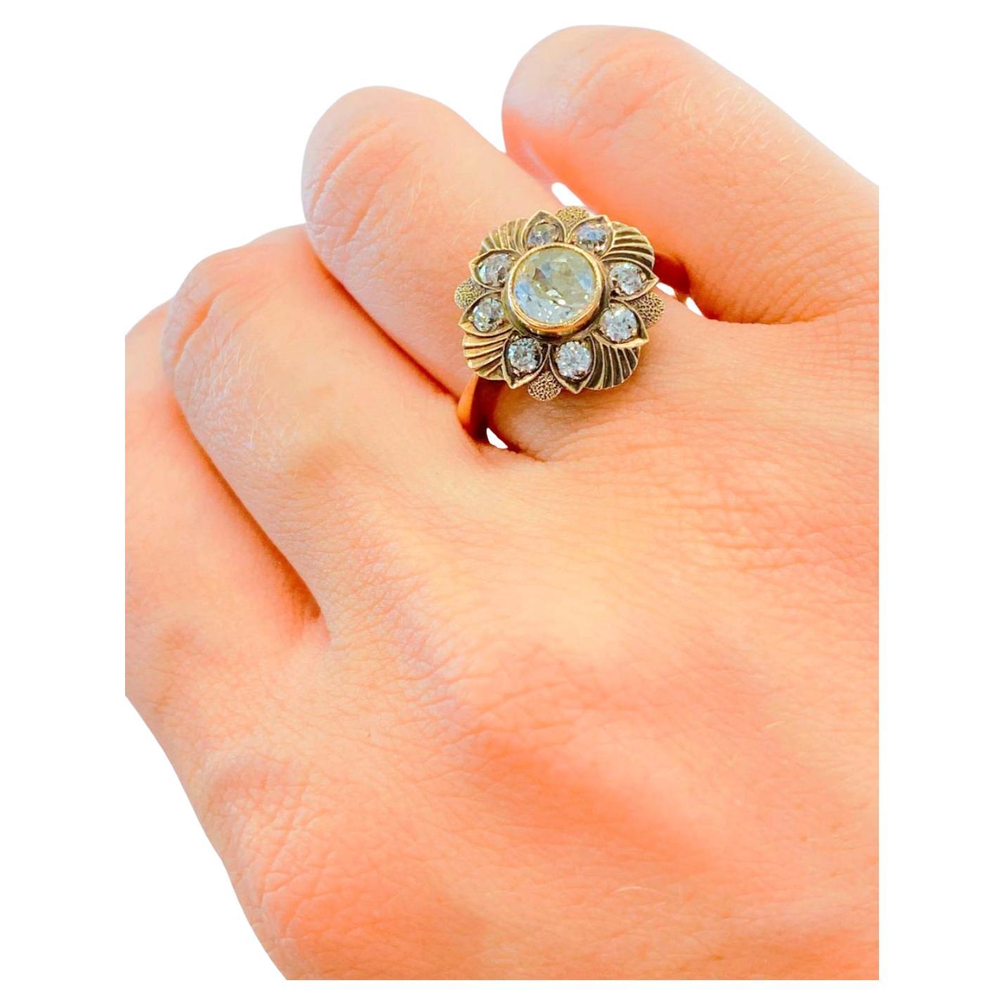 Antique Russian solitaire ring in floral prongs design centered with 1 old mine cut diamond estimate weight of 1.25 carats and 7mm diameter I color vs clearity and ring head diameter 14mm hall marked 56 imperial Russian gold standard and cocause