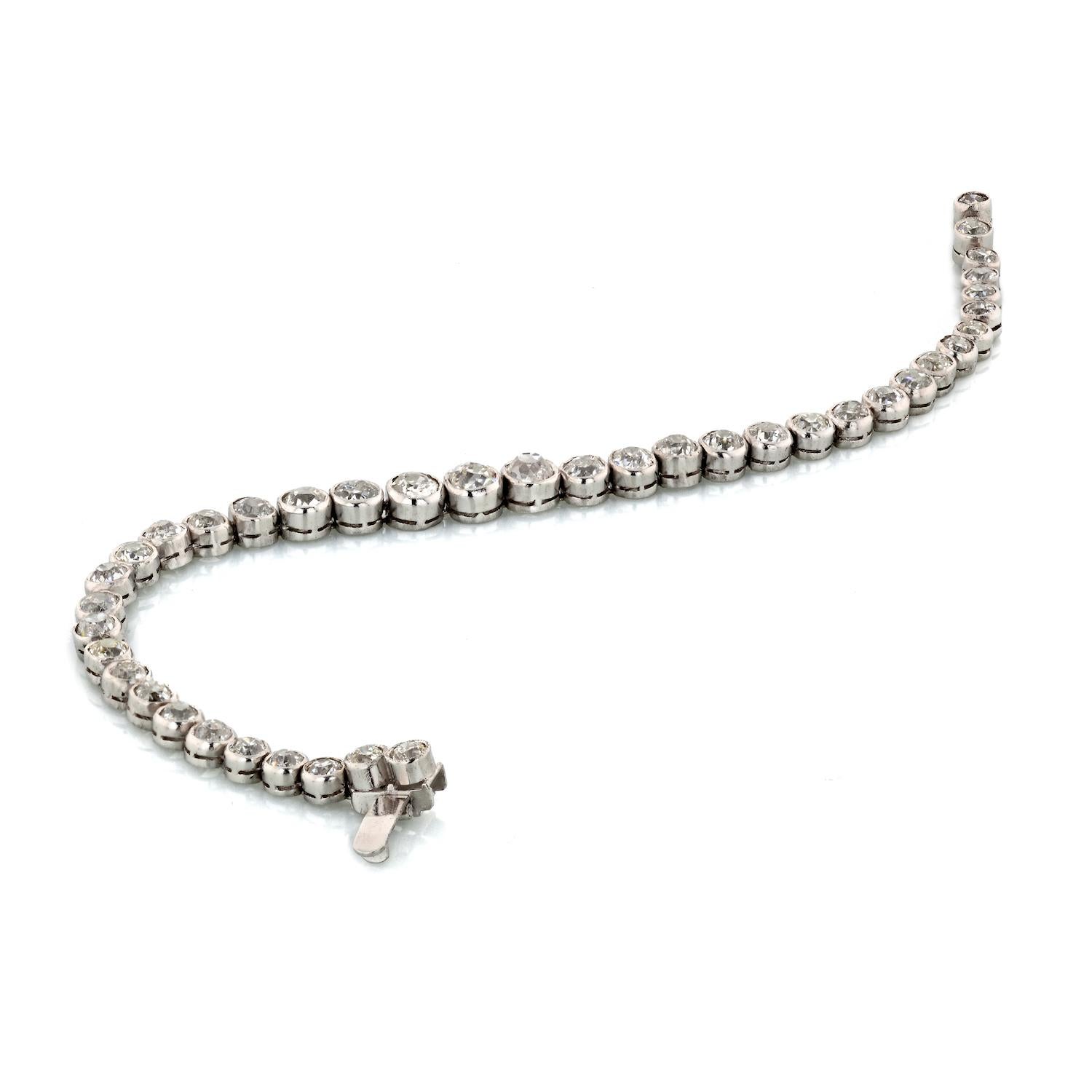 This is an absolutely stunning and original antique tennis bracelet that was handmade during the 1930's era from platinum.  The bracelet is bezel-set with 40 old cut diamonds that have a total weight of approx. 10.00cttw. These diamonds are all