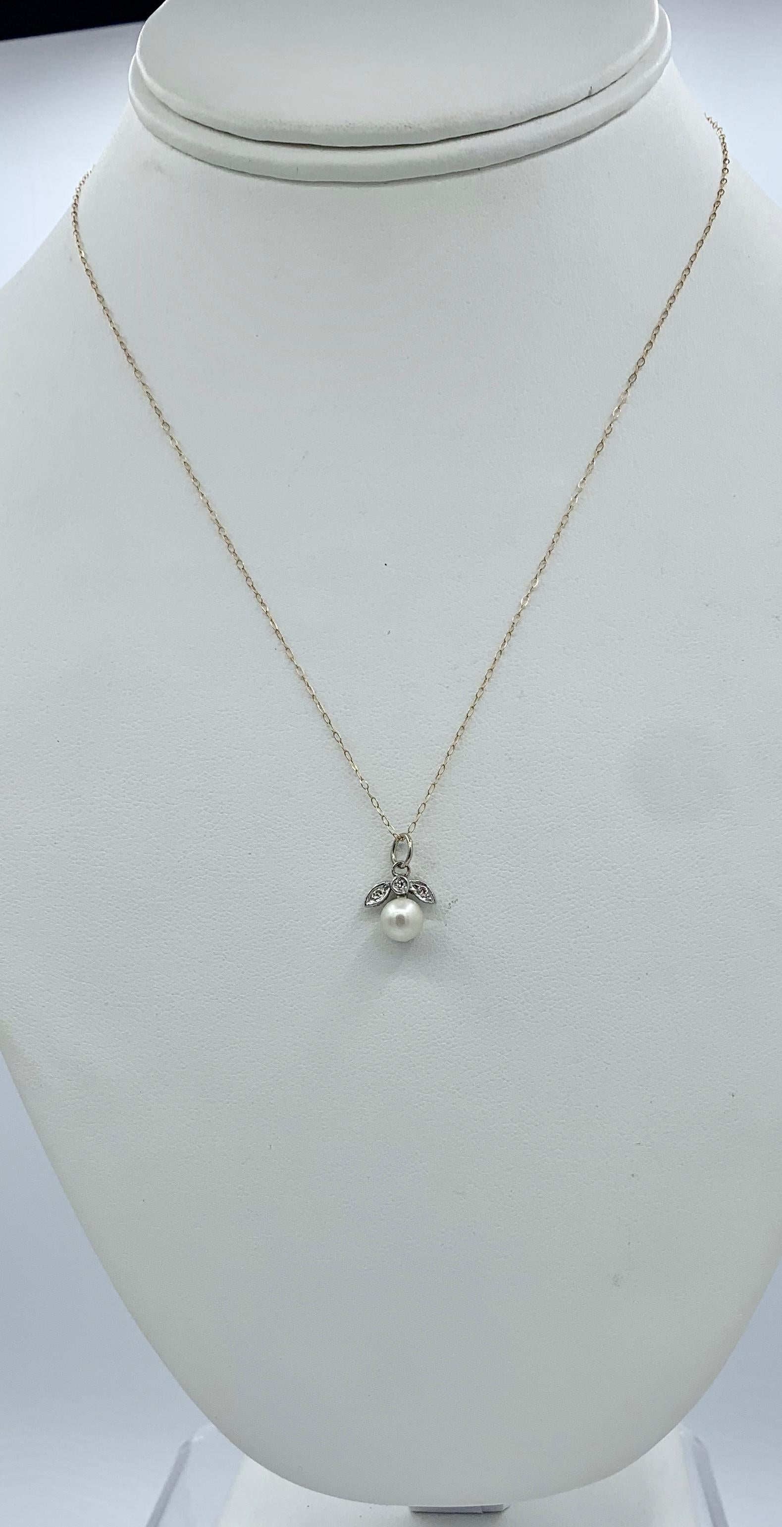 A wonderful original Art Deco - Victorian - Belle Epoque pendant or charm in a fruit, flower motif with a stunning White Pearl hanging from a leaf motif set with Old Mine Cut Diamonds in 10 Karat White Gold.  The pendant dates to circa 1860-1920. 