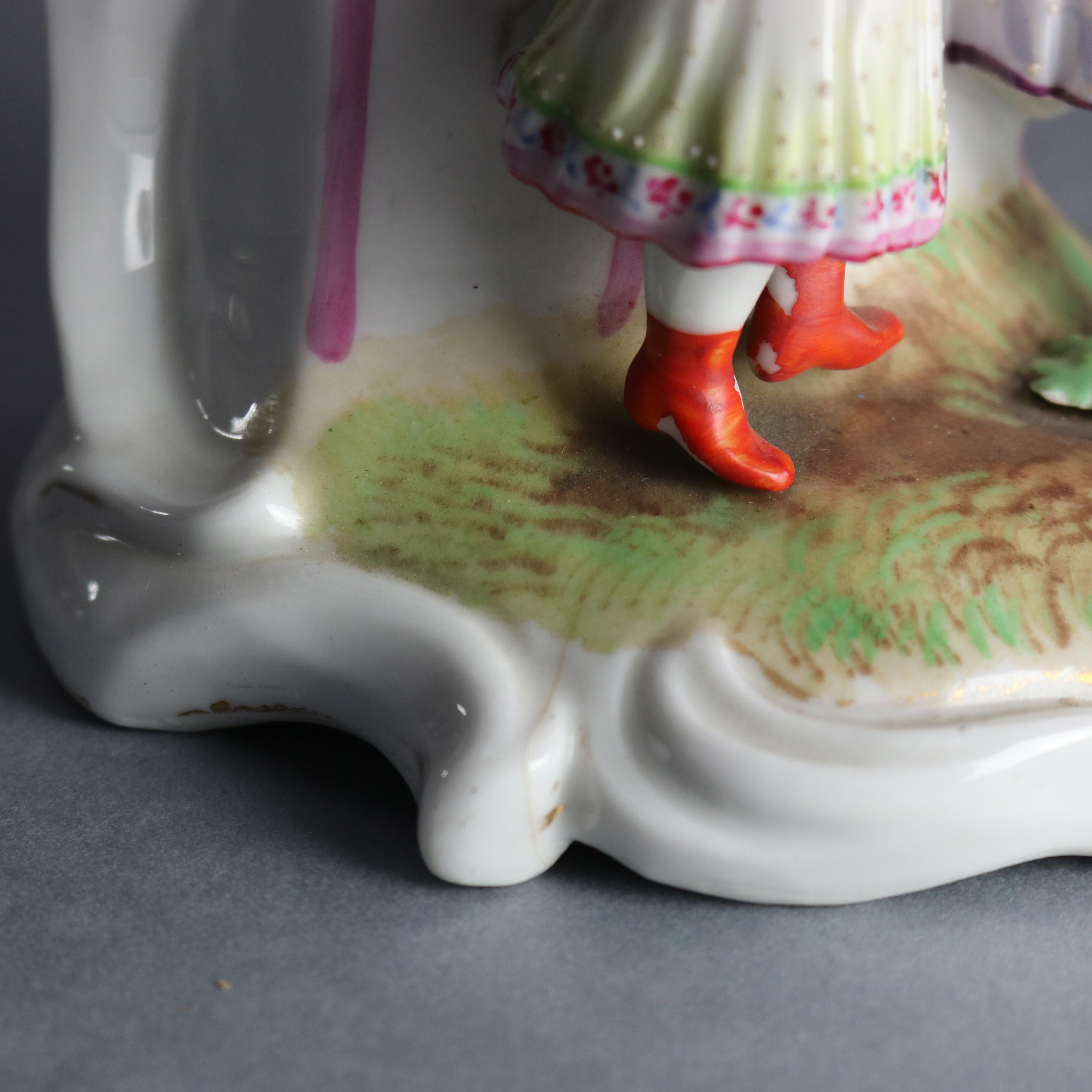 An antique Old Paris figural spill vase offers porcelain construction with mother and child picking graped, marked and numbered on base as photographed, circa 1880.

Measures: 11