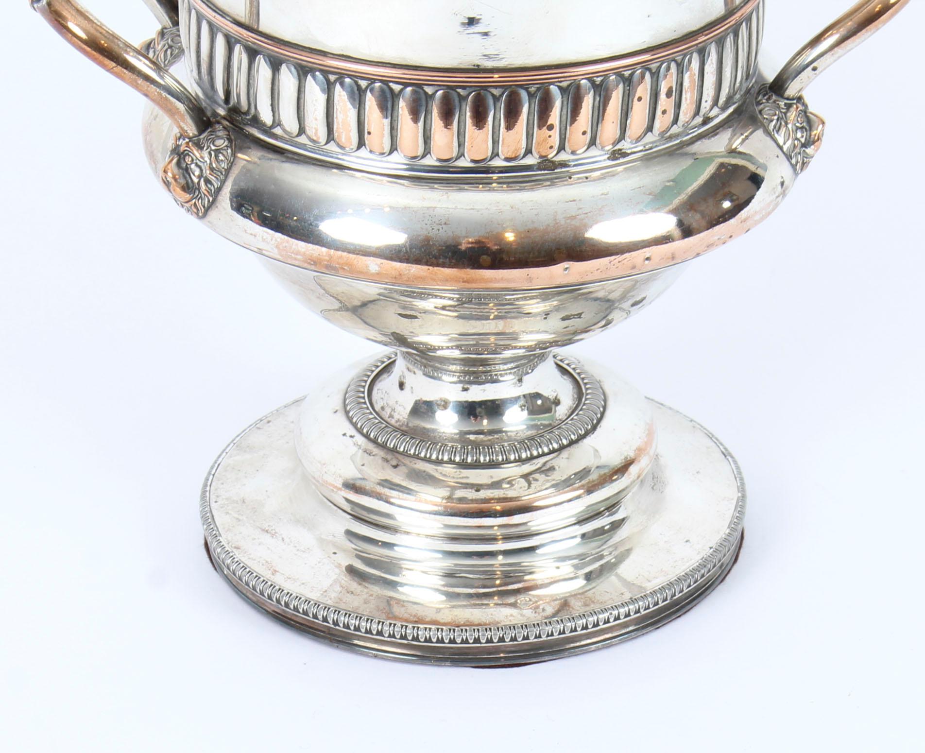 This is an exceptional antique English old Sheffield plate silver on copper wine cooler, circa 1820 in date.
 
The wine cooler stands on a widespread circular pedestal base and the body and rim are embellished with applied bands of fluting. It has