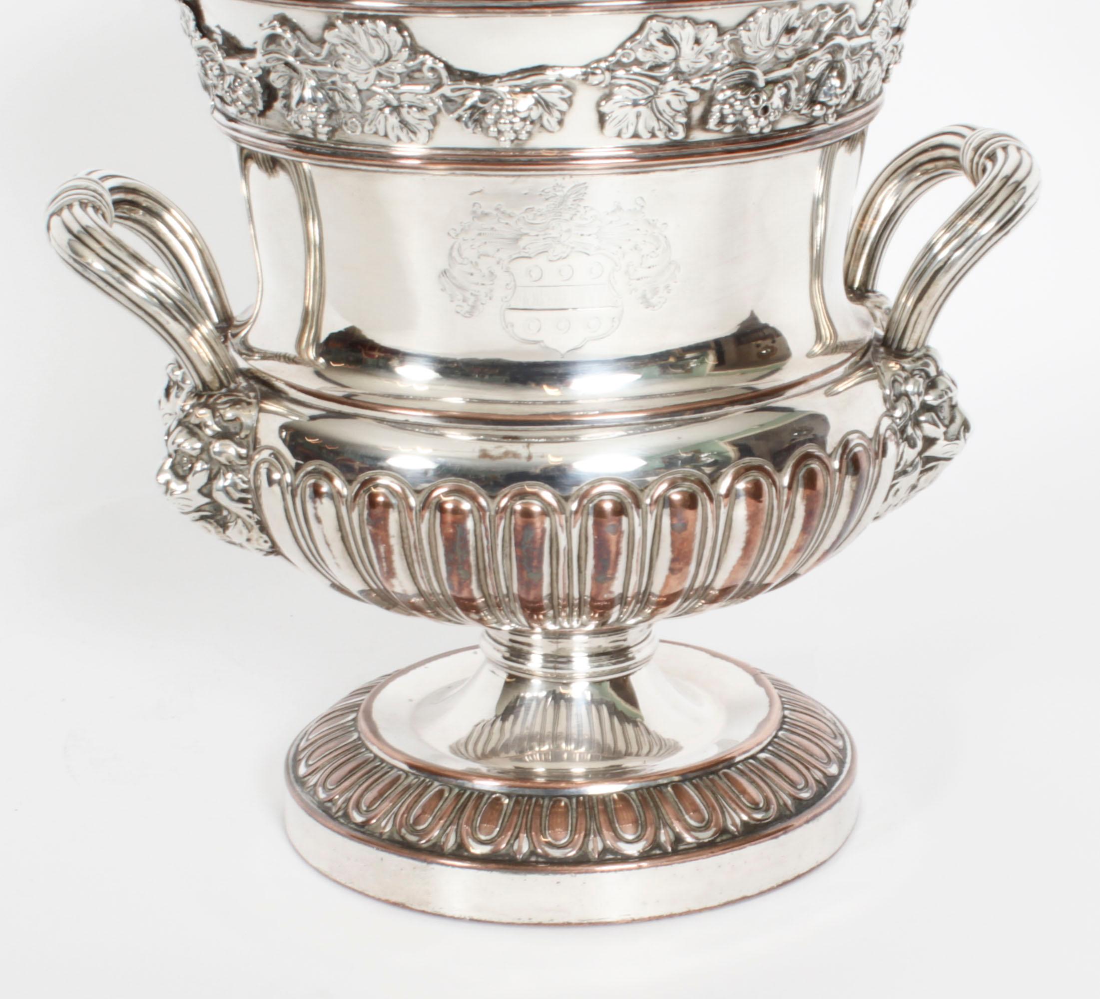 This is a wonderful and rare antique English Old Sheffield Plate, silver on copper, Regency wine cooler of campana form, circa 1820 in date.
 
The cooler features a ribbed two-handled maskhead urn shaped body with fluted band and pedestal foot