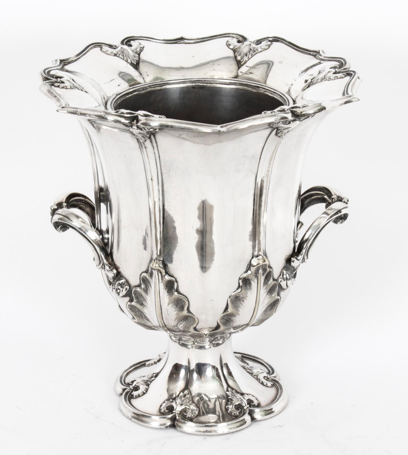 This is a wonderful and rare  antique English Old Sheffield Plate, silver on copper, wine cooler of campana form, Circa 1780 in date.
  
It is fitted with an exceptional pair of decorative handles and is embellished with chased and embossed foliate