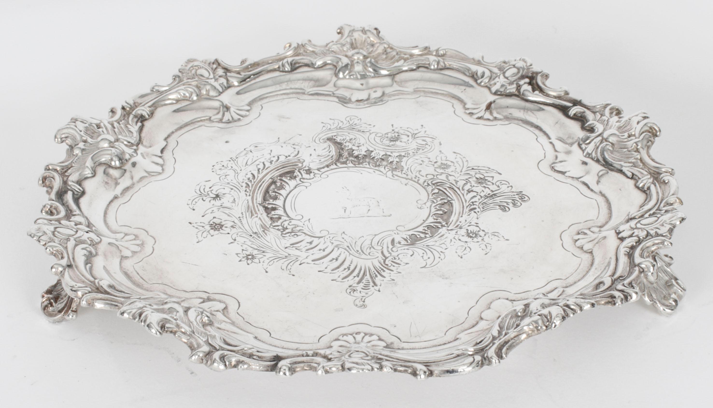 This is an exquisite English antique old Sheffield Plate salver bearing the makers mark ( a hand) for Smith, Tate, Nicholson and Holult, circa 1810 in date.
 
The elegant raised pie crust border shaped salver features hand chased foliate engraving