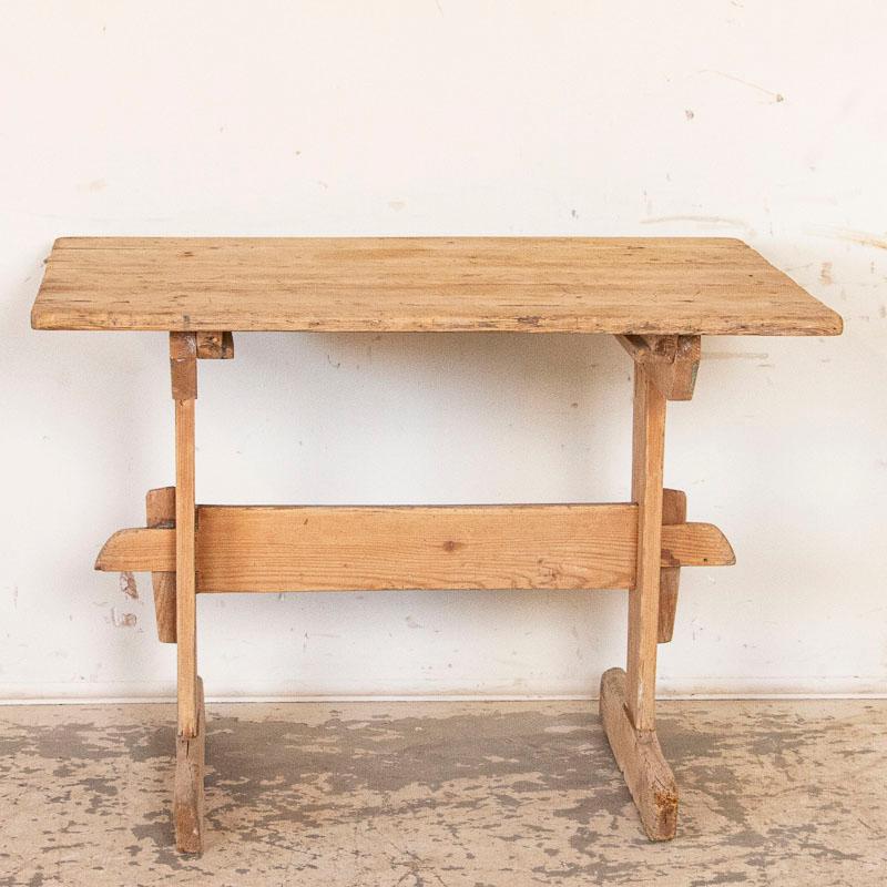 This side table is loaded with character thanks to the generations of use it received as a small work table as seen in the distress, scrapes, cracks, gouges etc. Please examine photos well to appreciate the wear, and some age-related separation of