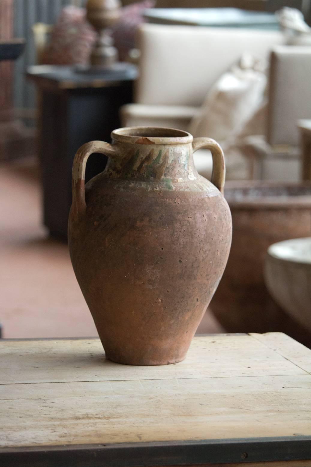 Antique Turkish terra cotta olive oil pot with two handles.