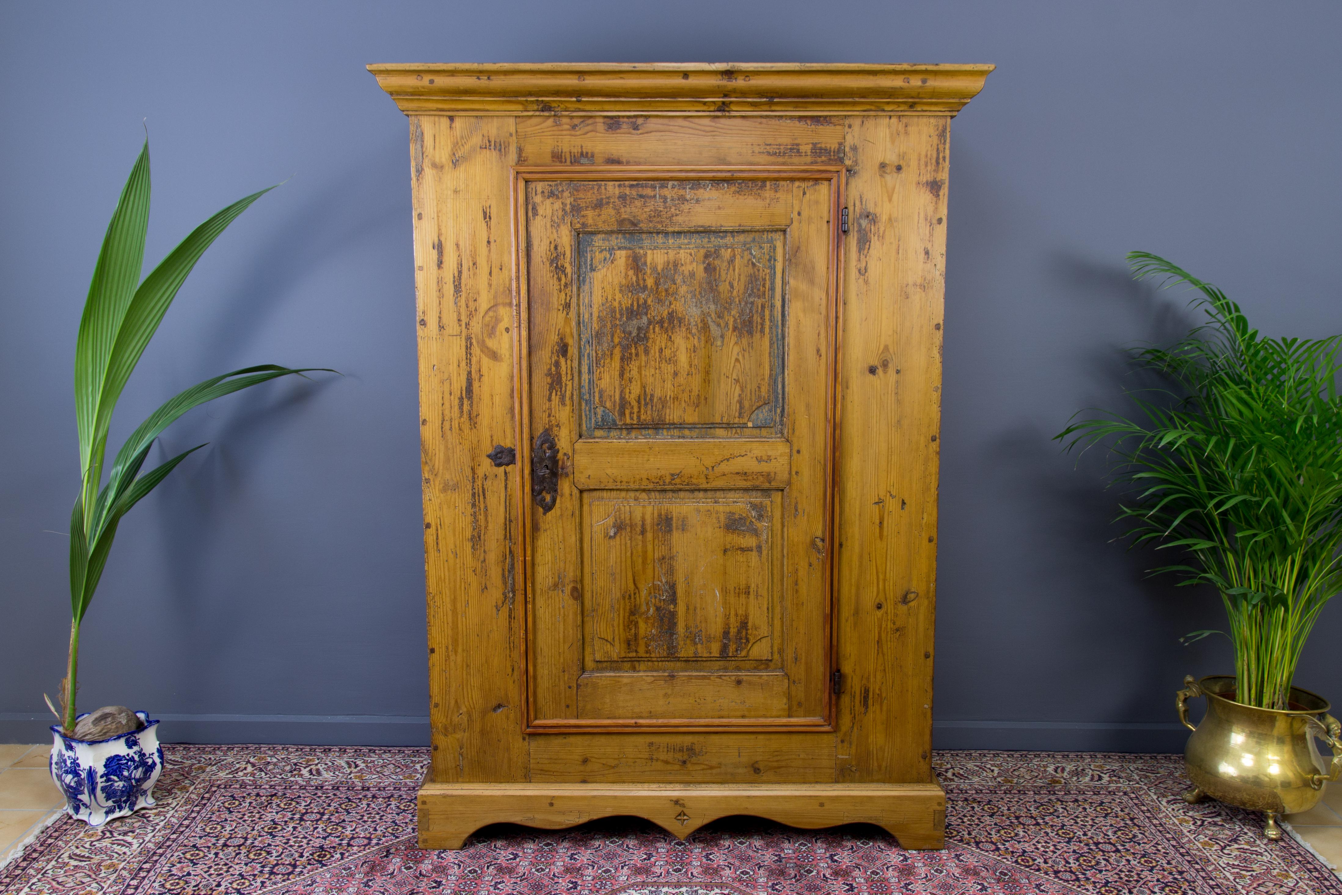 This unique and antique one-door Baltic pine armoire or wardrobe was handcrafted and hand-painted in the middle of the 19th century. The armoire is dated 1852, but it could have been made earlier. There are three shelves, one small interior drawer,