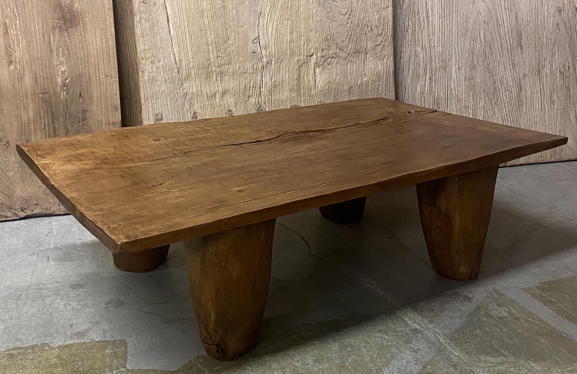 This honey colored coffee table is made from a one wide board top from the highlands of Guatemala. The top is 19th  century and was carved and cut using a traditional machete. The conical legs were added to make this a gorgeous coffee table. Wax