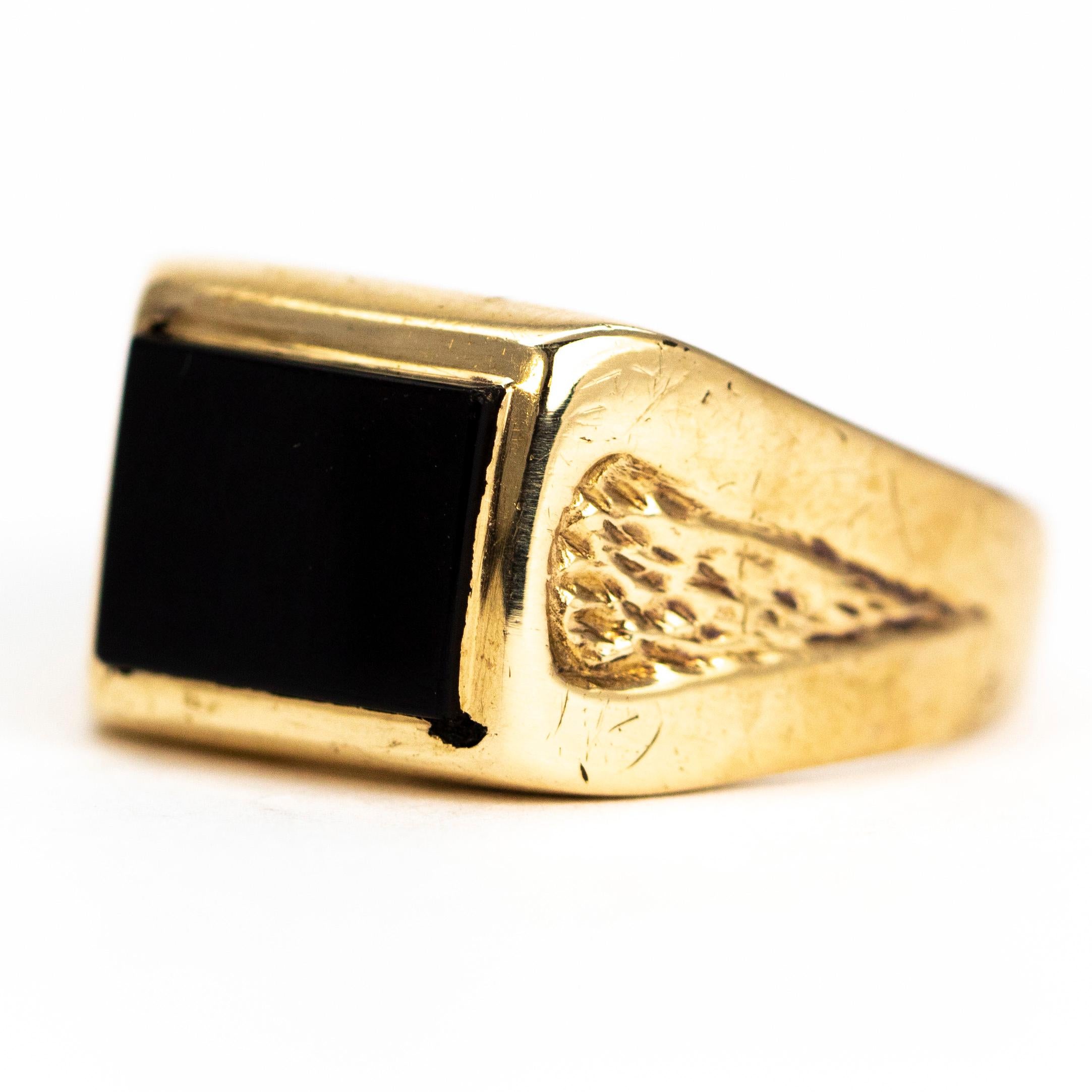 Either Side of the gorgeous glossy onyx is a panel of textured gold etched into the shoulders of this chunky ring. The onyx is crisply cut into a rectangle and set within the 9ct gold band. Made in London, England.

Ring Size: S 1/2 or 9 1/4
Stone
