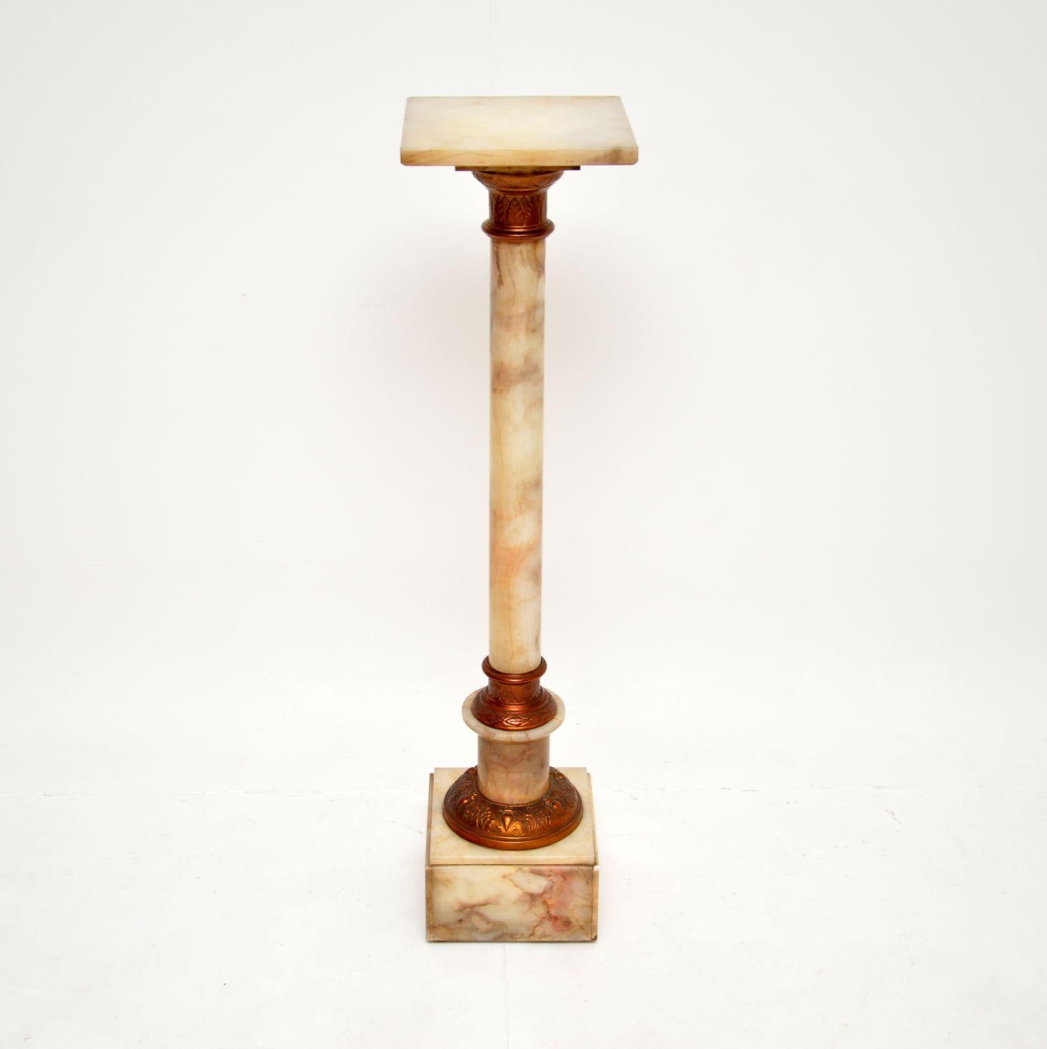 A beautiful and useful antique onyx and brass column. This was made in England, it dates from around the 1910 period.

It is of excellent quality, the onyx has gorgeous colours and swirling patterns. This has brass fixtures at the base and under the