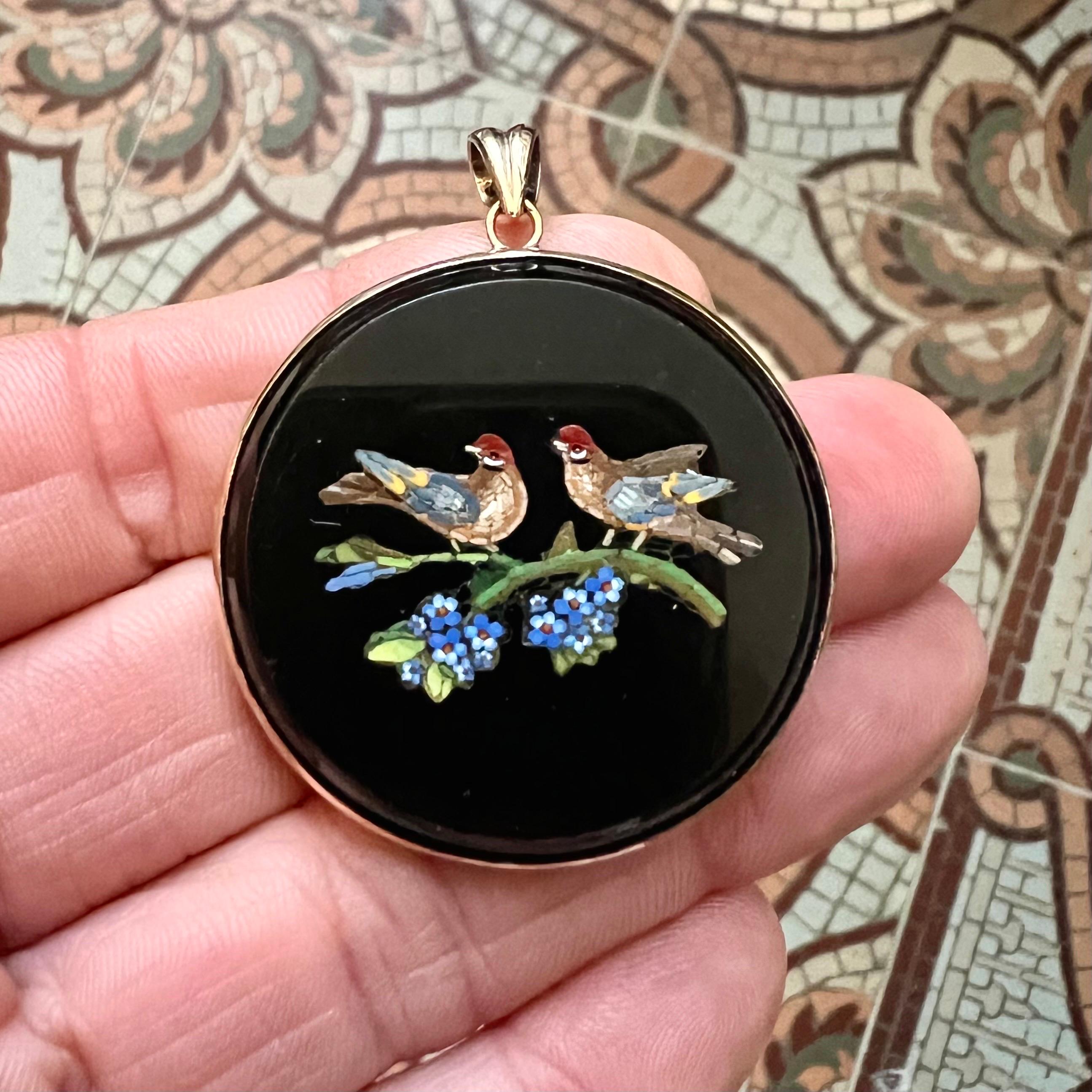 This exquisite antique pendant, crafted in Rome during the 19th century, is a testament to the exceptional artistry and craftsmanship of the era. Featuring a delicate micro mosaic design set on a round polished onyx base, the piece is a striking