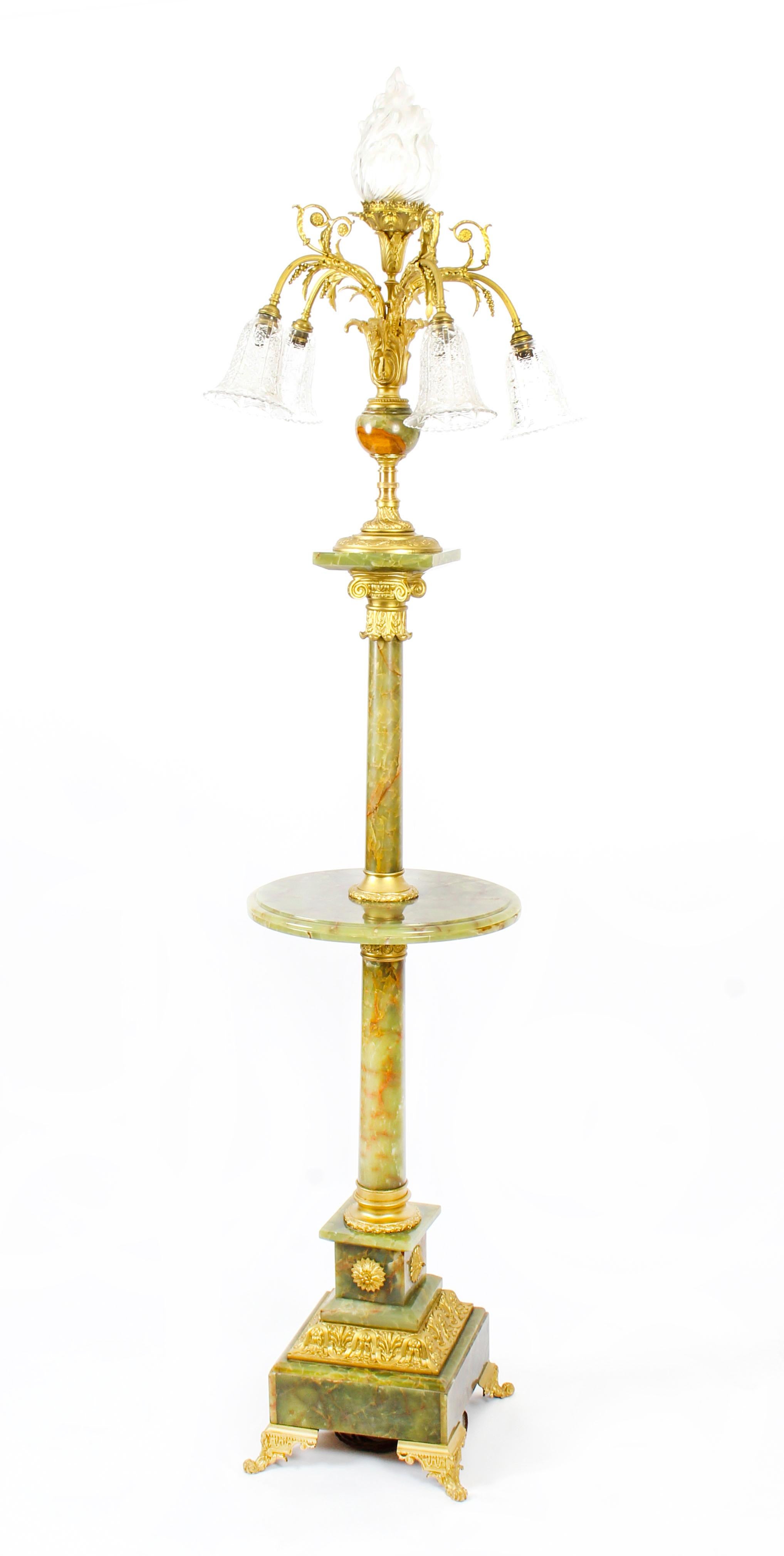 This is a truly stunning antique onyx and ormolu Louis XVI Revival floor standard lamp, circa 1900 in date.
 
This exceptional lamp features a stunning flaming torch at the top surrounded by five further exquisite branches with beautiful cut glass