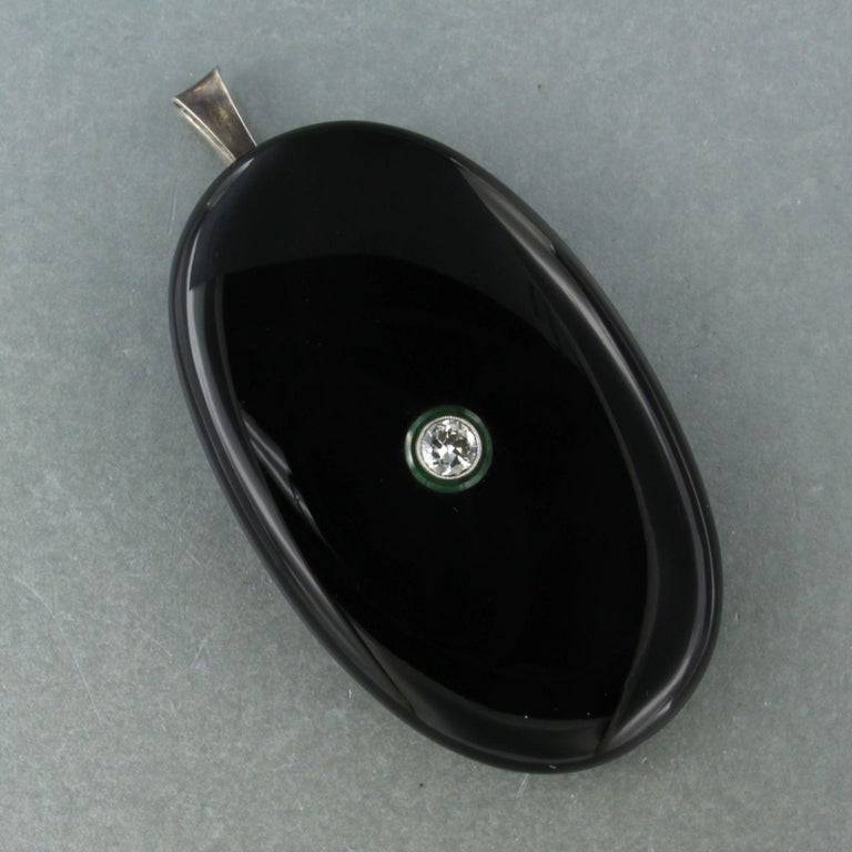 Antique Edwardian mourning pendant

Crafted from onyx, set on 835 silver.

With old European cut diamond 0.45 carat, and green garnet.

Weight : 24.3 gram
Dimensions : 6.0 cm x 3.7 cm 