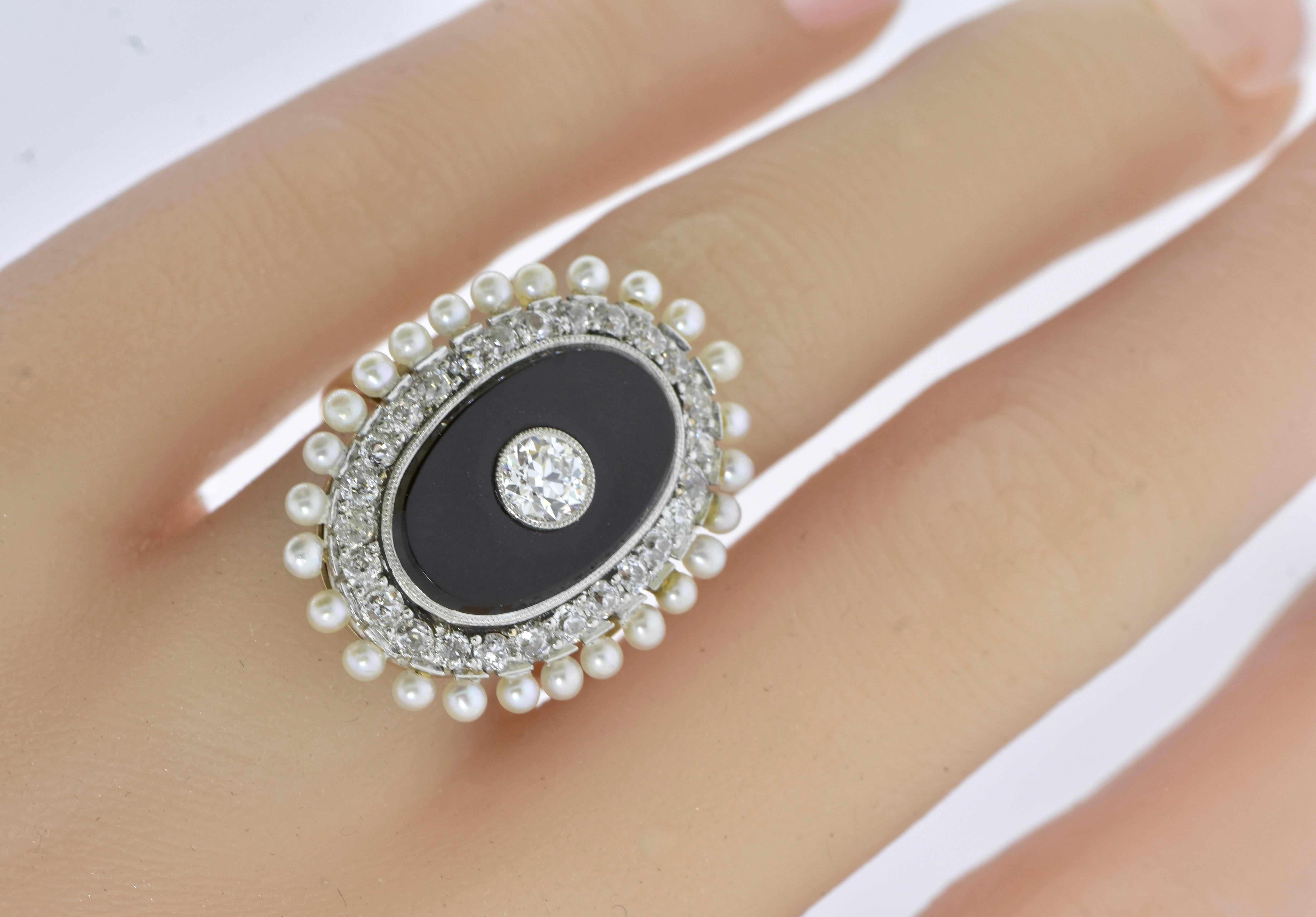 Antique onyx, diamond and natural oriental salt-water pearl ring, circa 1900.  This is an appealing and unusual design that skillfully marries white. natural pearls, diamonds and onyx in a very noticeable way.

The center of the ring consists of a