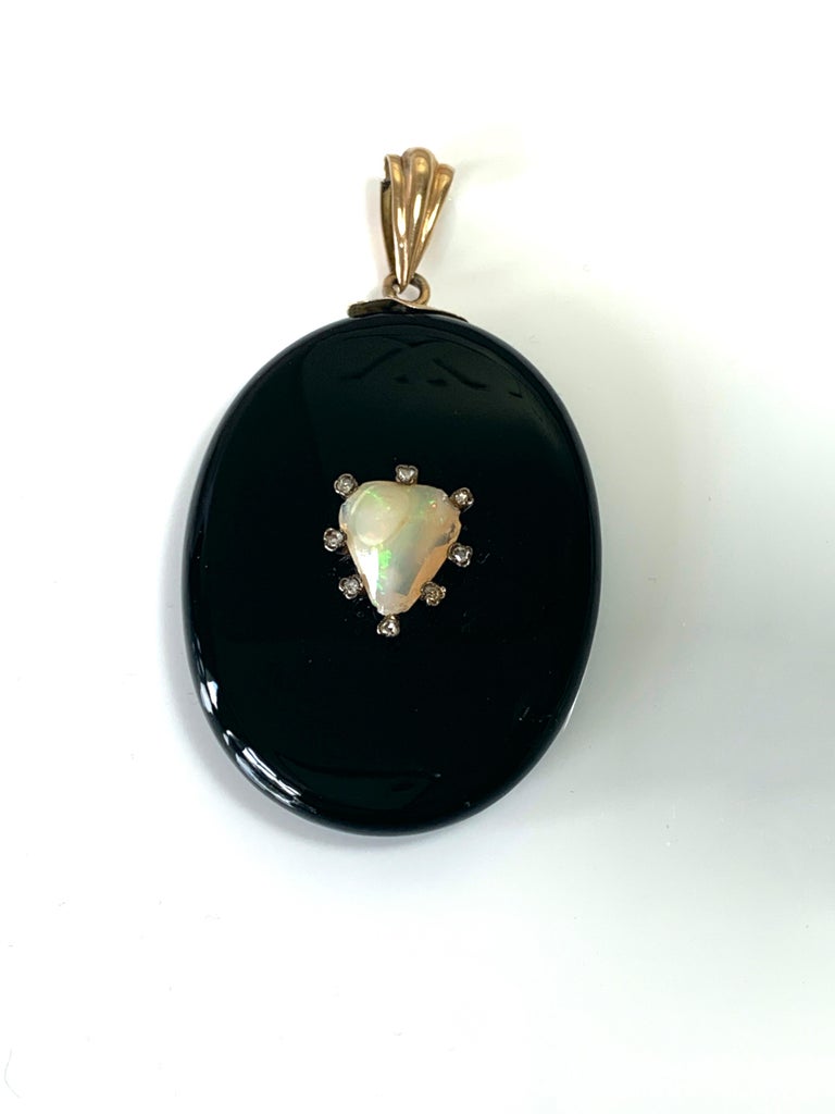 Antique Edwardian Mourning locket
with a hand cut Central Opal Heart (13mm x 10mm)
surrounded by eight mine cut natural diamonds (approx 1.5-1.75mm each)
Crafted from Black onyx stone - set with  a high Carat gold Bail & Collar decoratively engraved