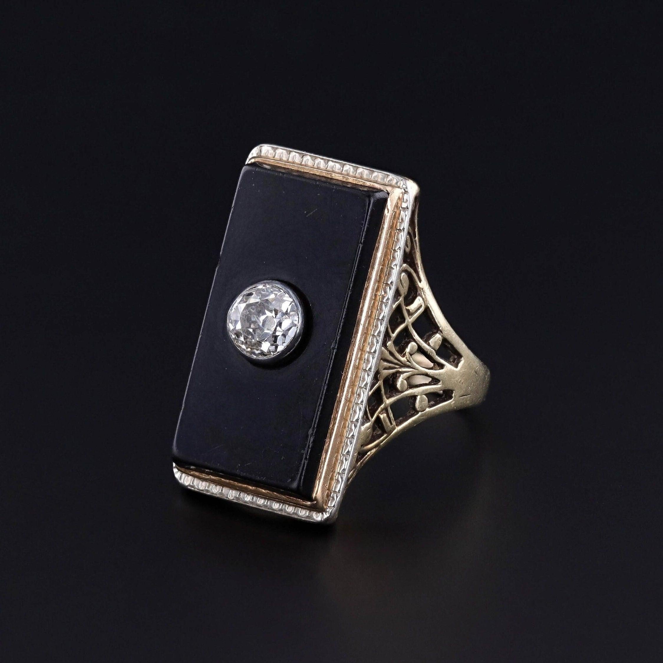 Antique Onyx and Diamond Ring: This antique ring dates to the early 1900s (circa 1910-1915). It features a stunning old European cut diamond set on onyx within a 14k yellow gold filigree mounting. The diamond is I color, SI1 clarity and weighs