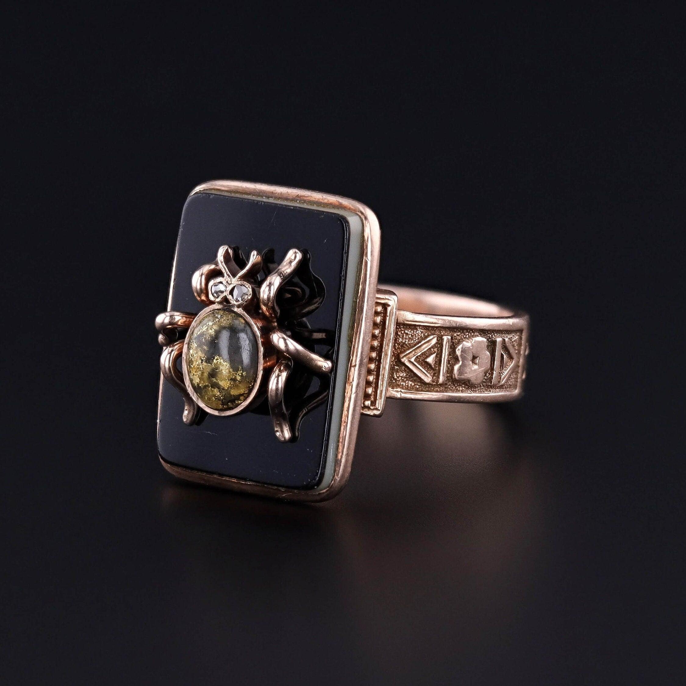 A unique 10k gold ring featuring a gold quartz insect with diamond eyes set atop an onyx backdrop. We created this one of a kind ring by riveting an antique, 14k gold, stickpin head (circa 1890) onto a signet ring (circa 1920).

The face of the ring